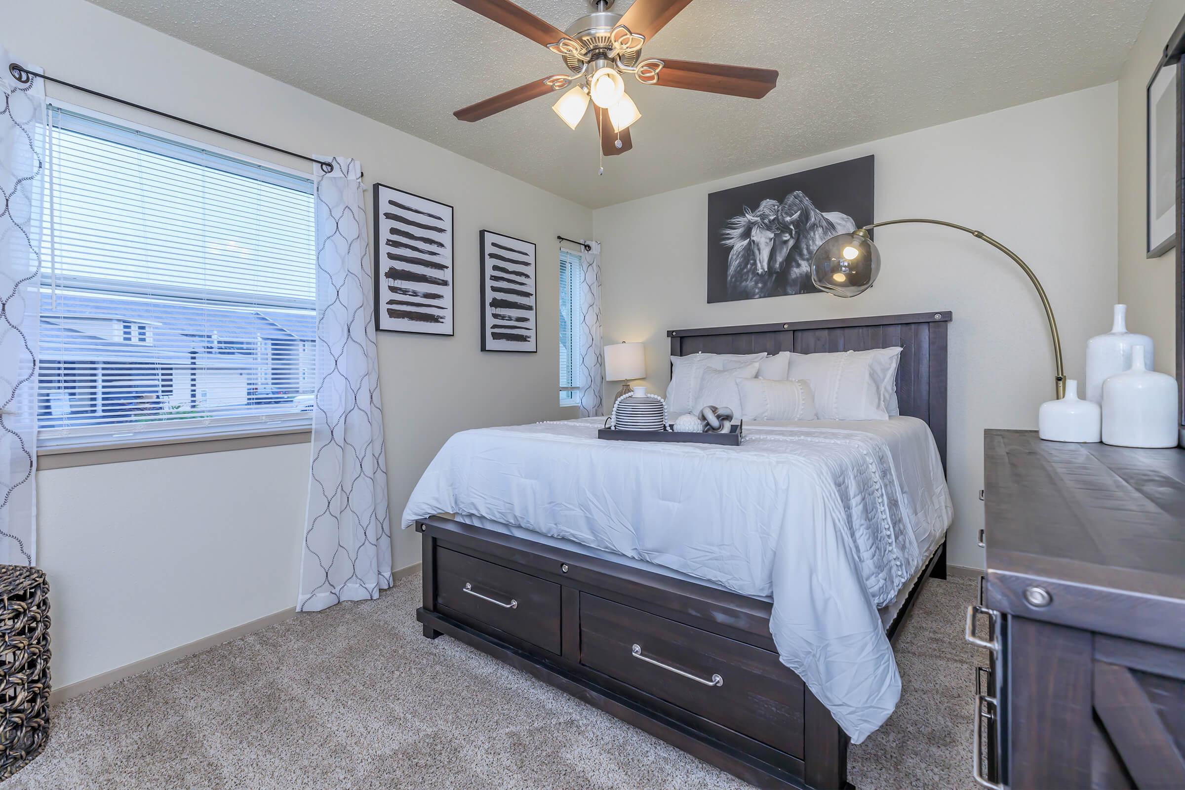 a bedroom with a bed and desk in a room