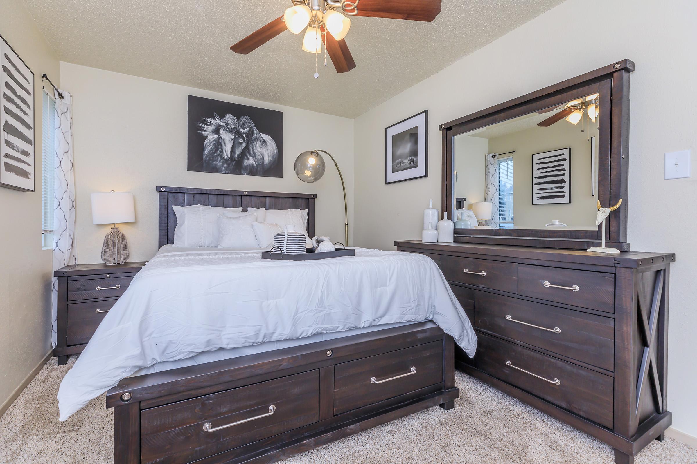 a bedroom with a bed and desk in a room