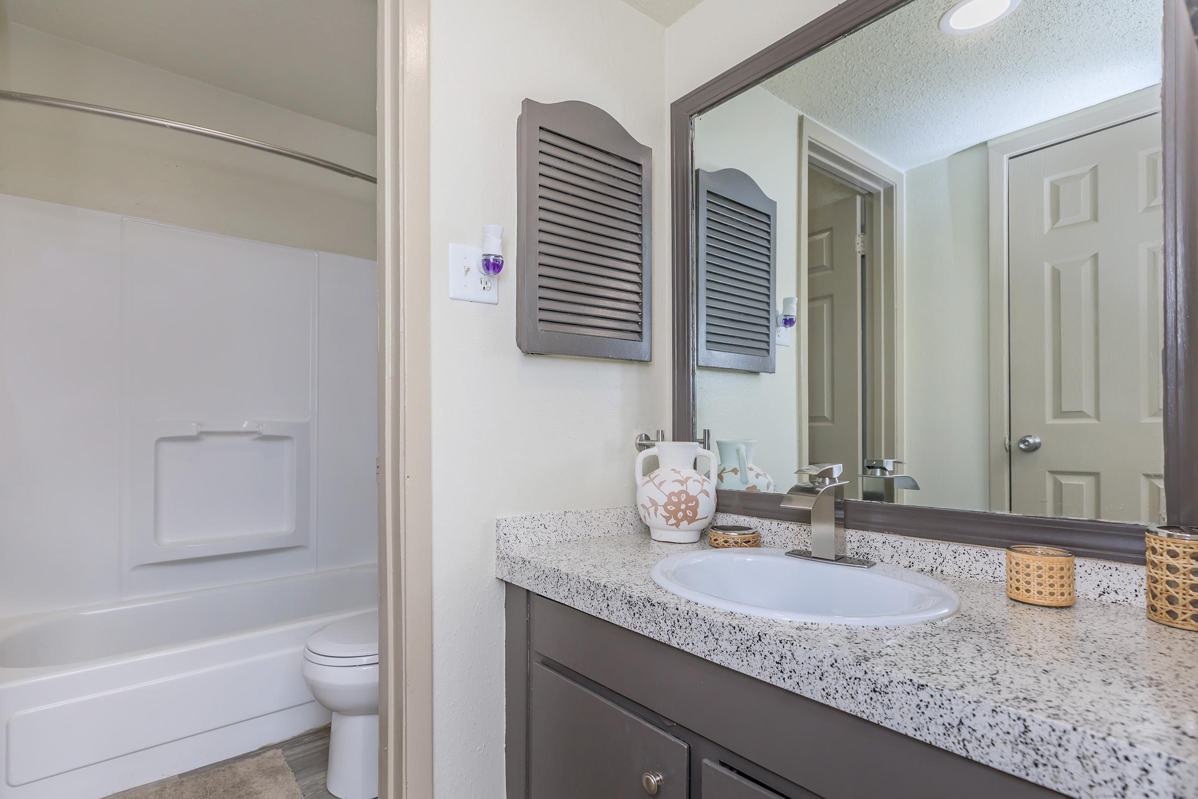 a kitchen with a sink and a mirror