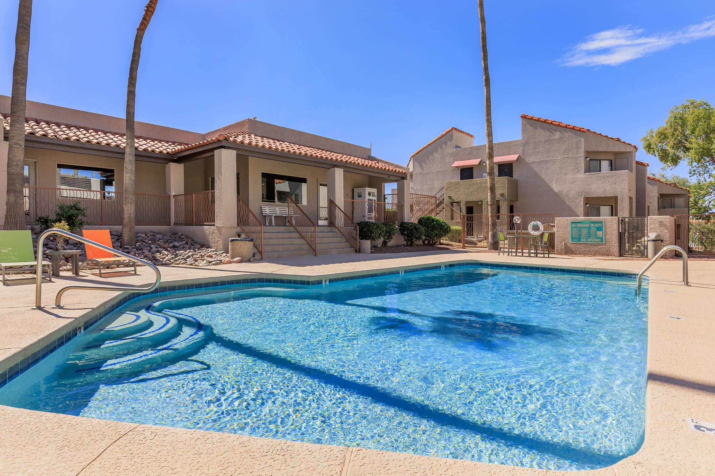 a house with a pool outside of a building