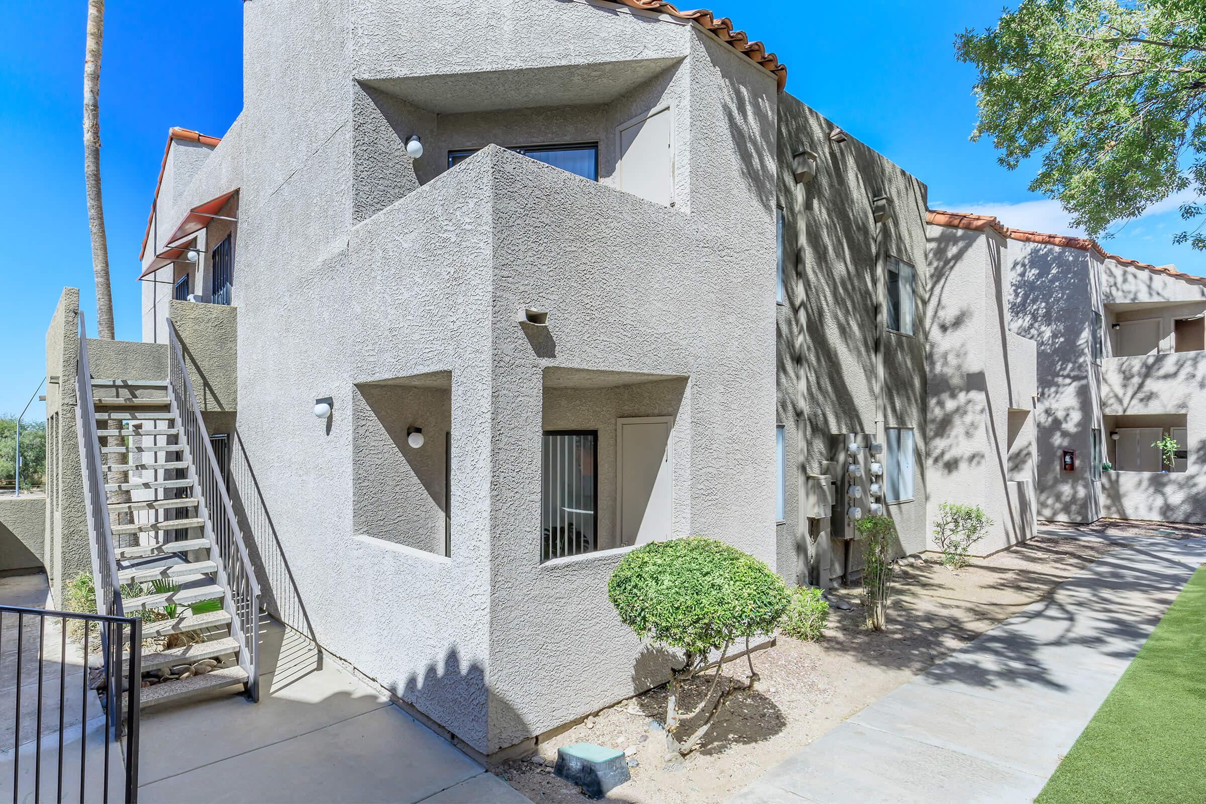 a stone building that has a bench in front of a house