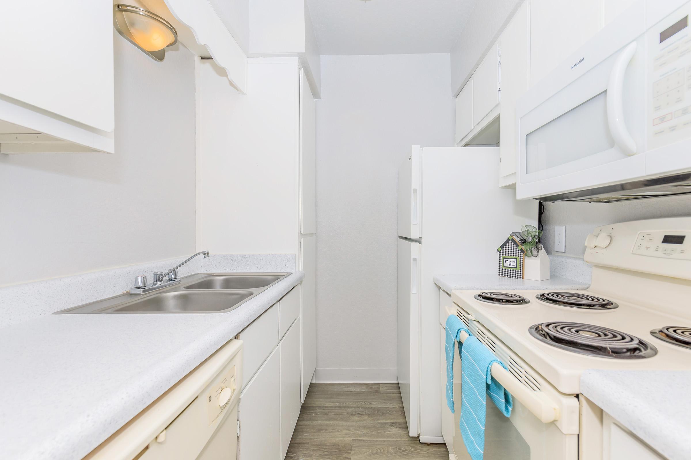 a kitchen with a stove sink and refrigerator