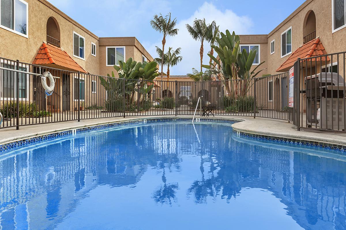 a house with a pool in front of a building