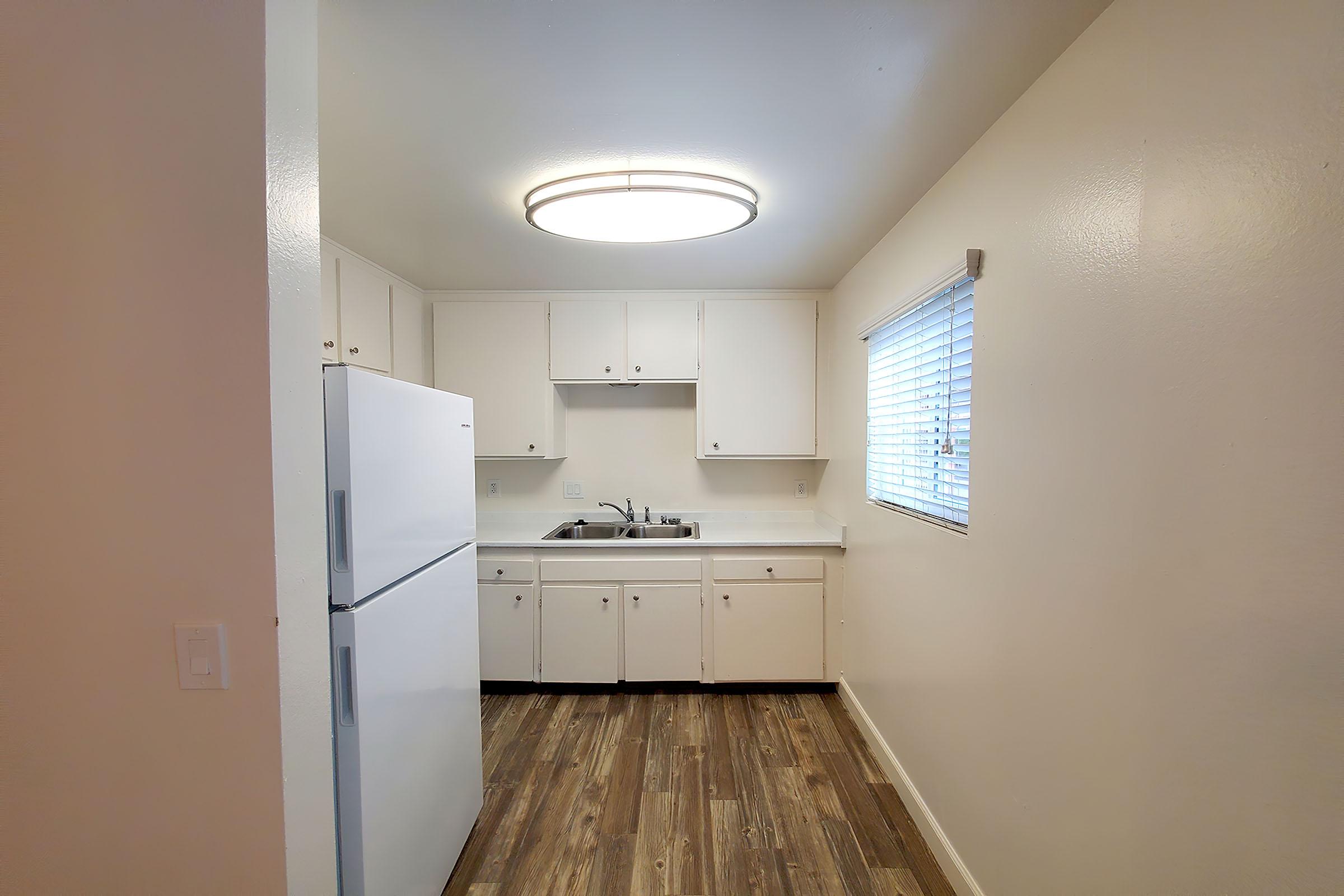 a kitchen with a sink and a mirror