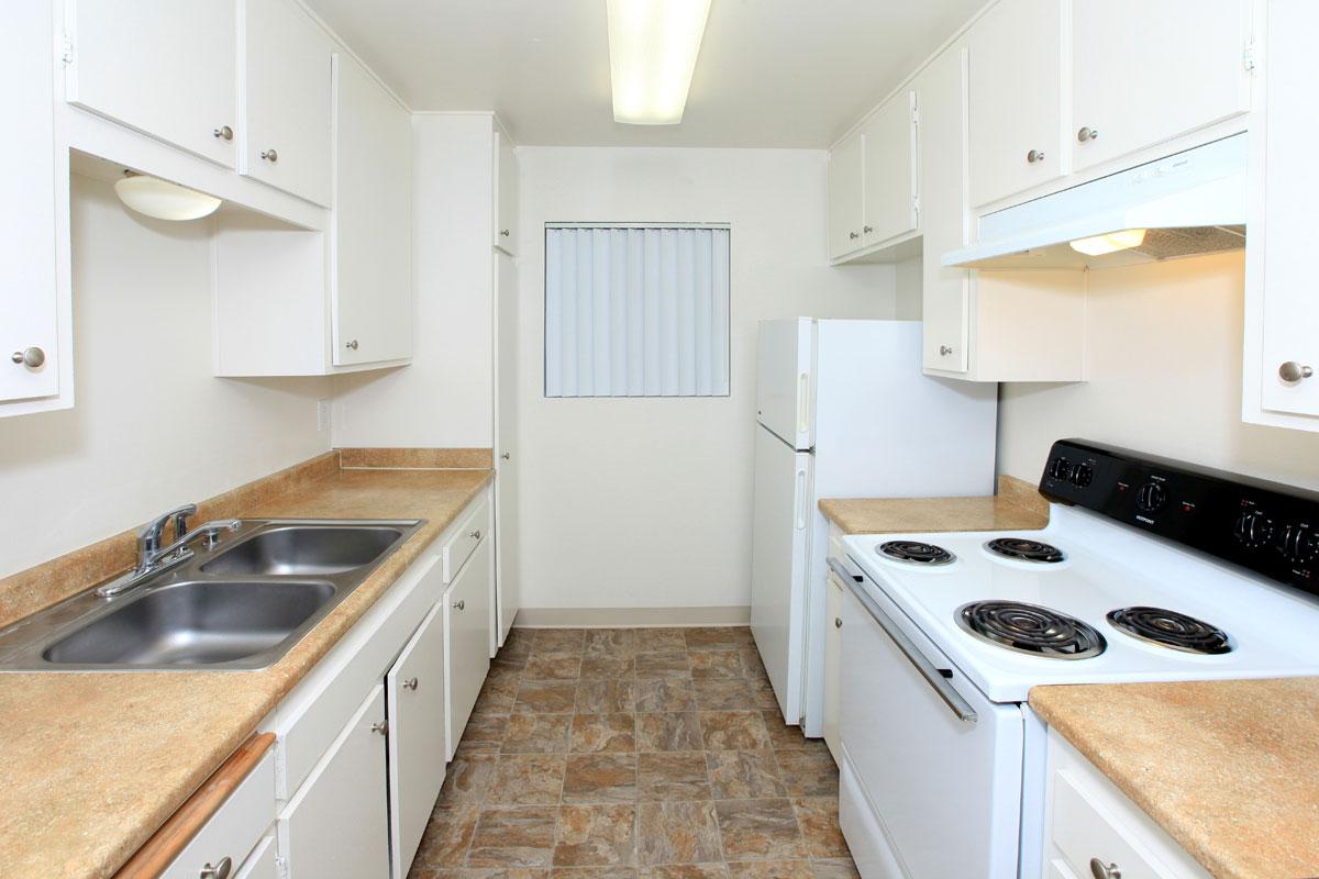 a kitchen with a white stove top oven