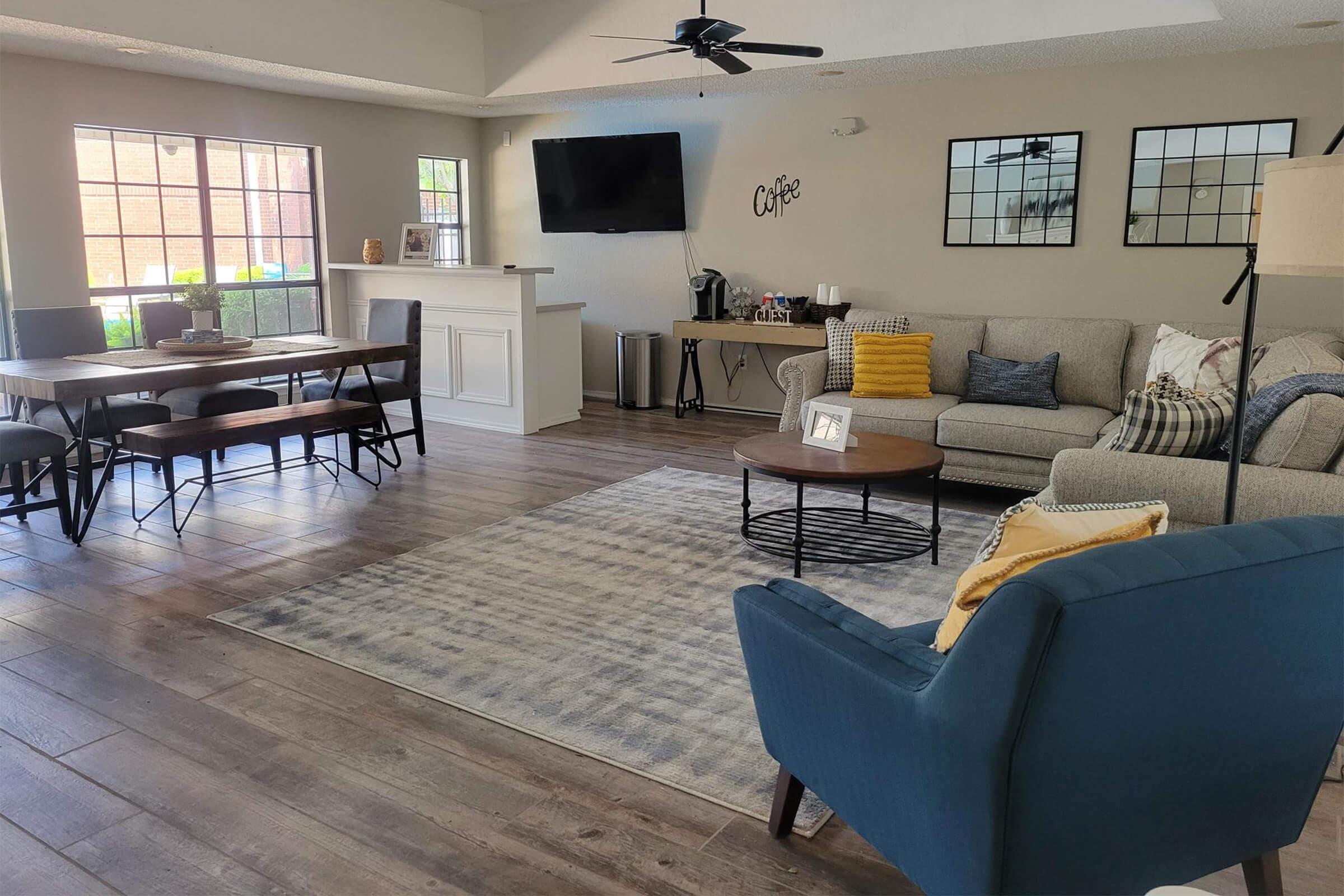 a living room filled with furniture and a large window