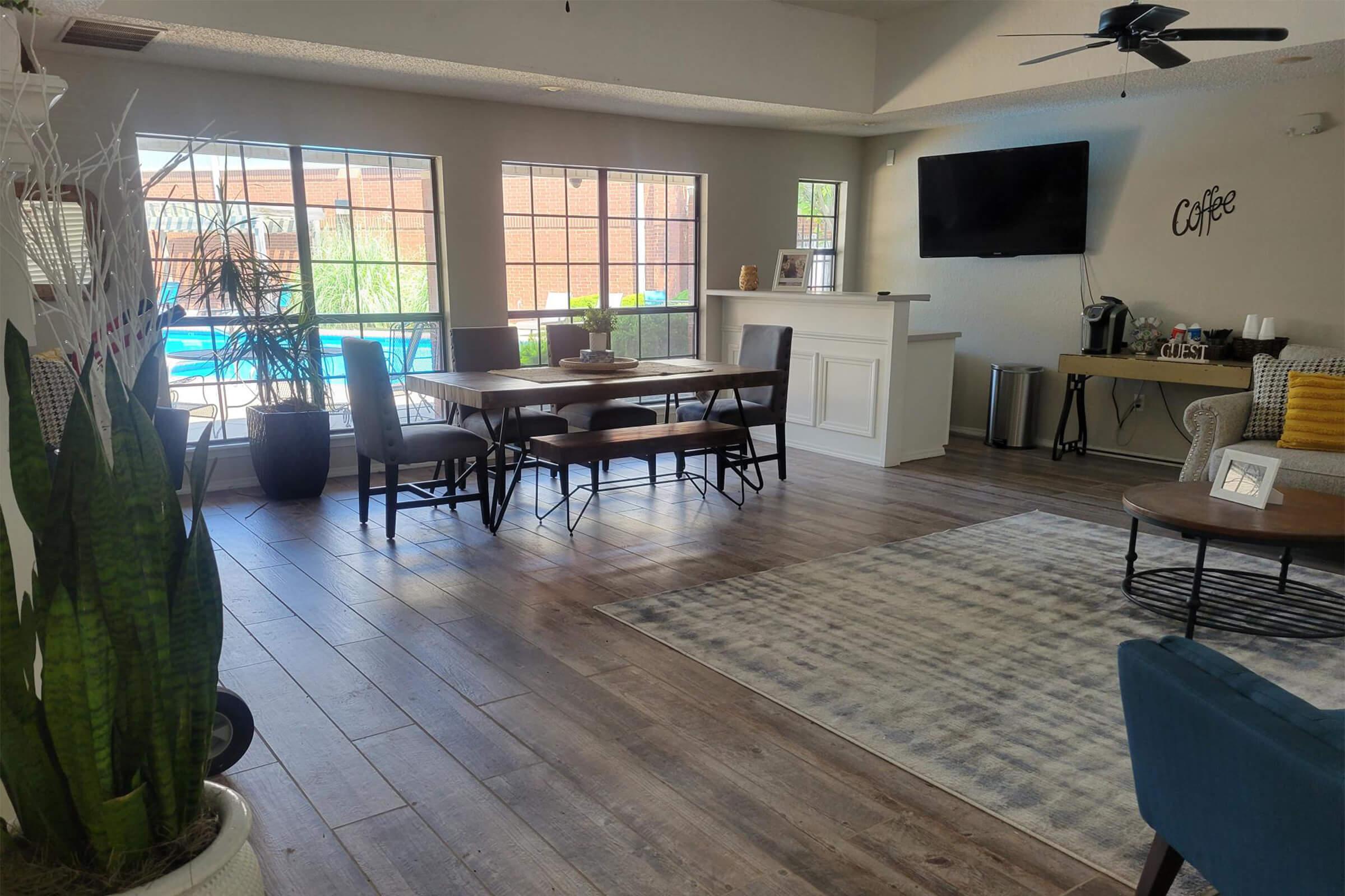 a living room filled with furniture and a large window