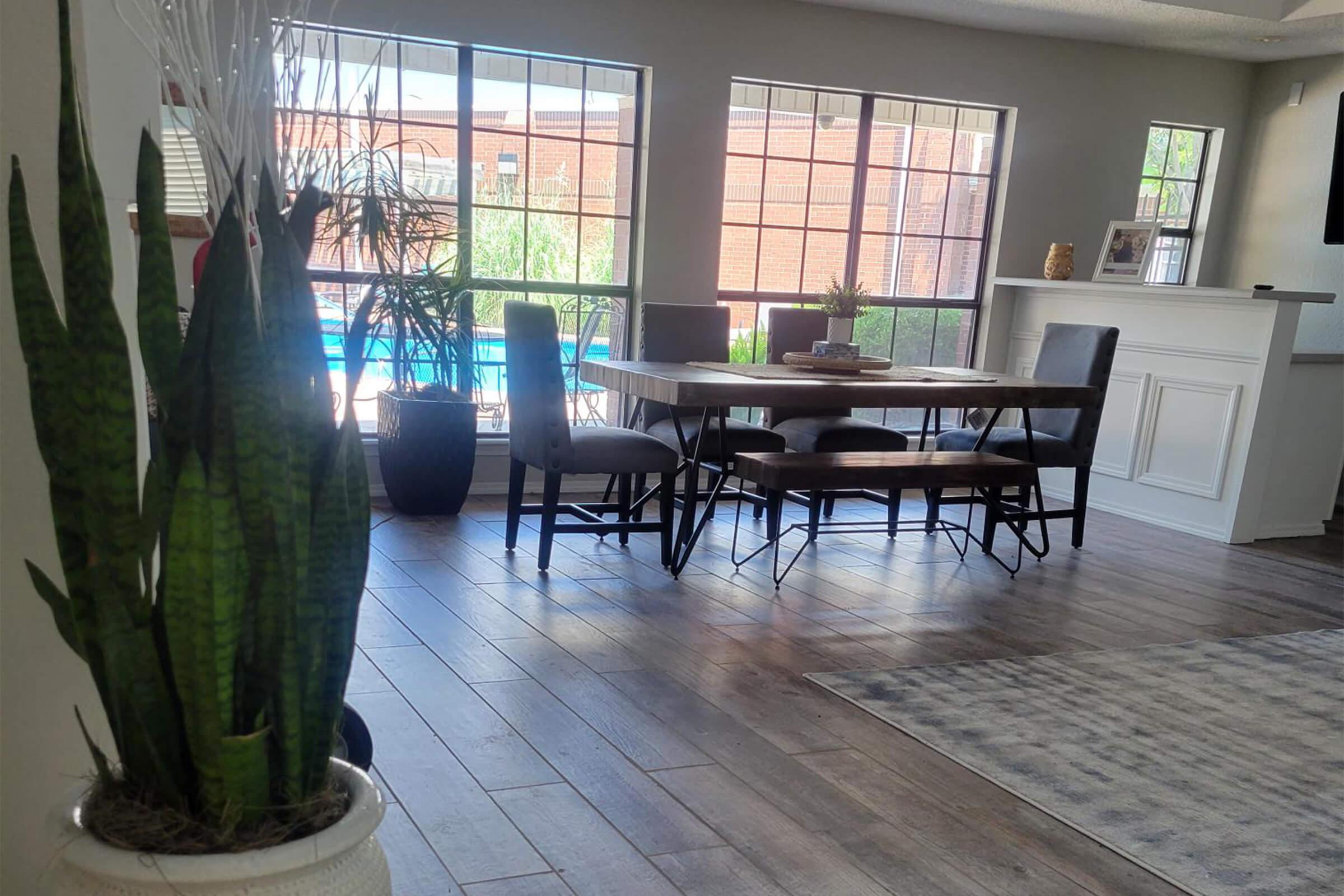 a room filled with furniture and vase of flowers on a table