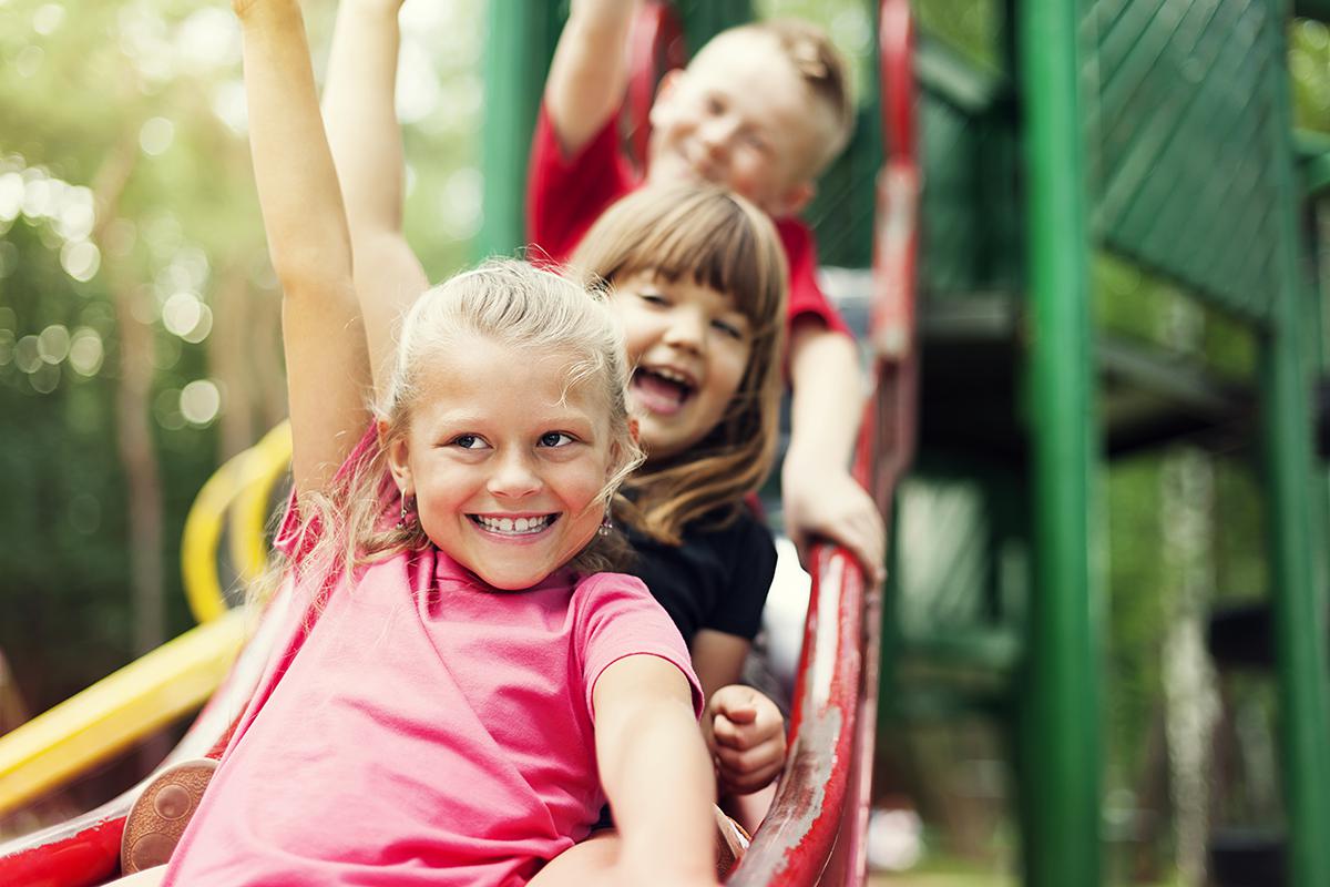 a little girl sitting on a swing