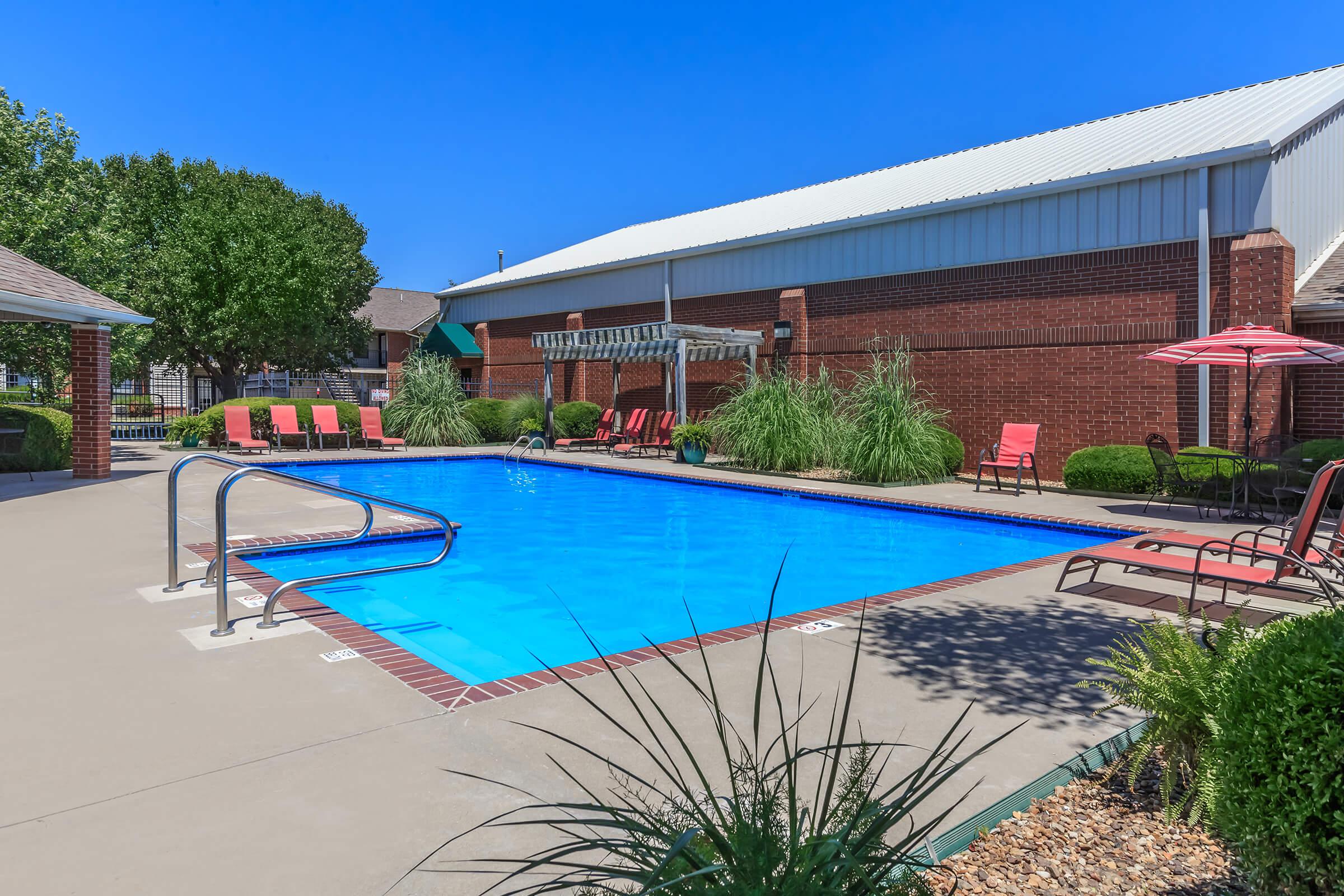 a large lawn in front of a pool