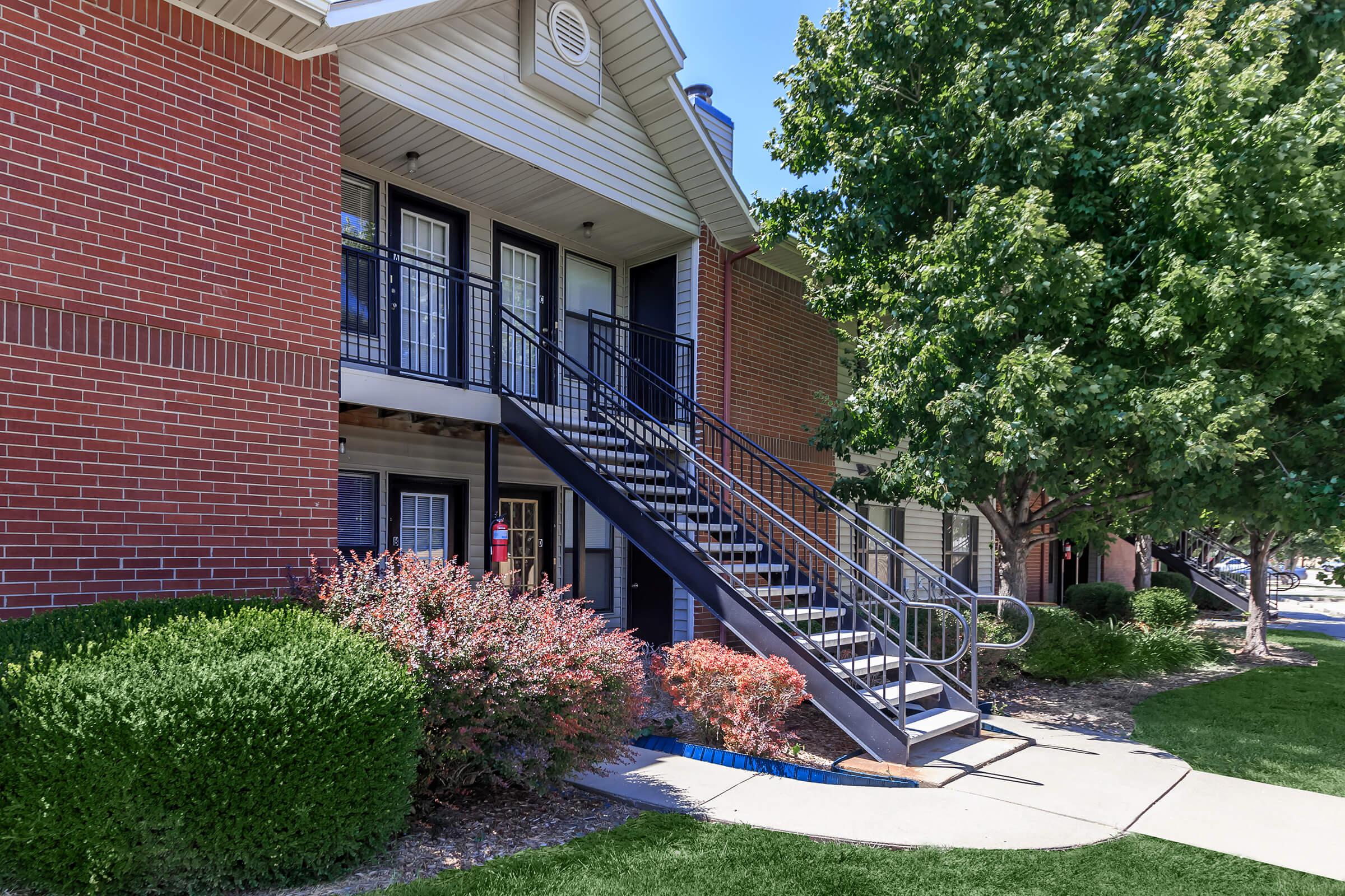 a large lawn in front of a brick building