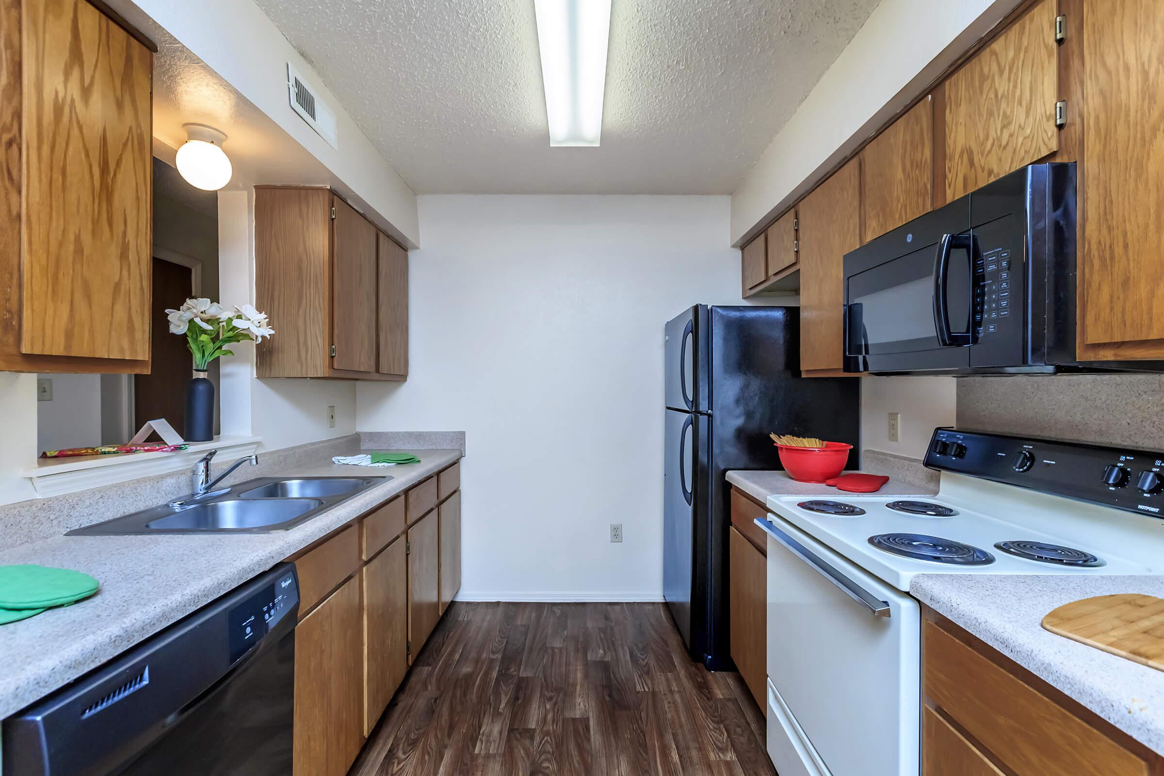 a modern kitchen with stainless steel appliances and wooden cabinets