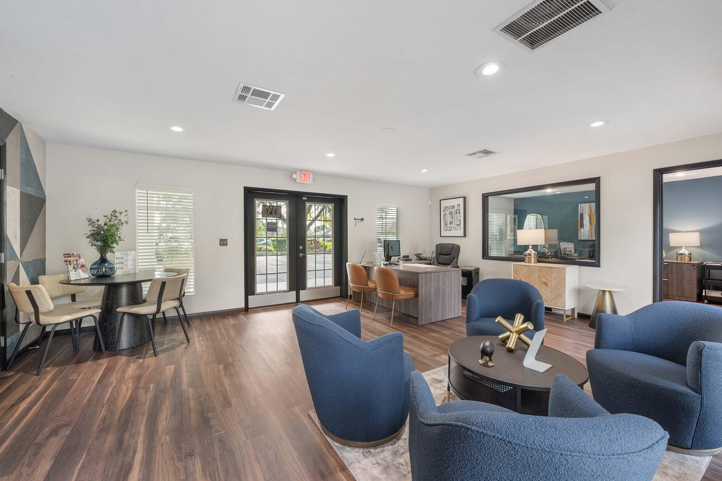 a living room filled with furniture and a large window