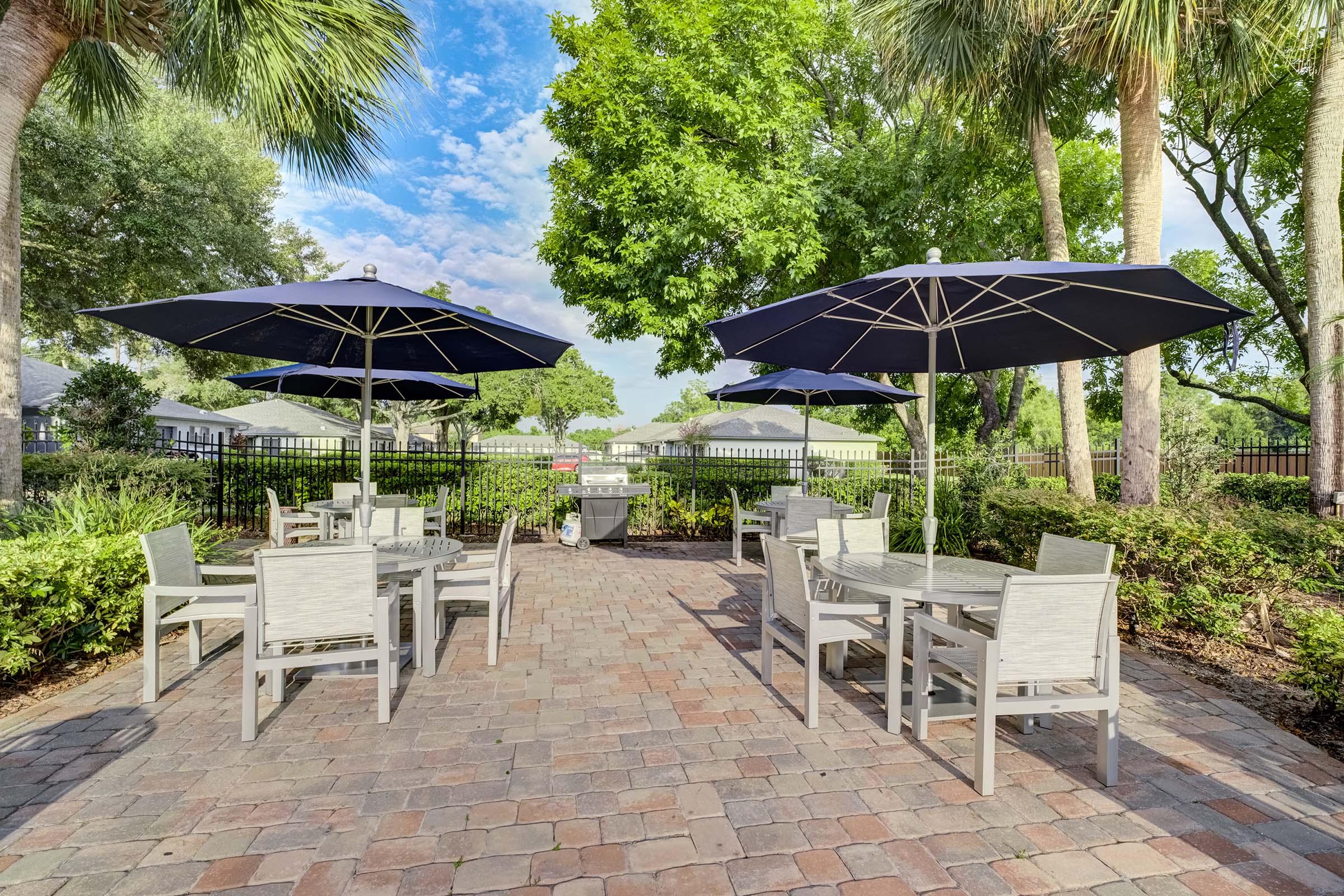 a group of lawn chairs sitting on top of a picnic table