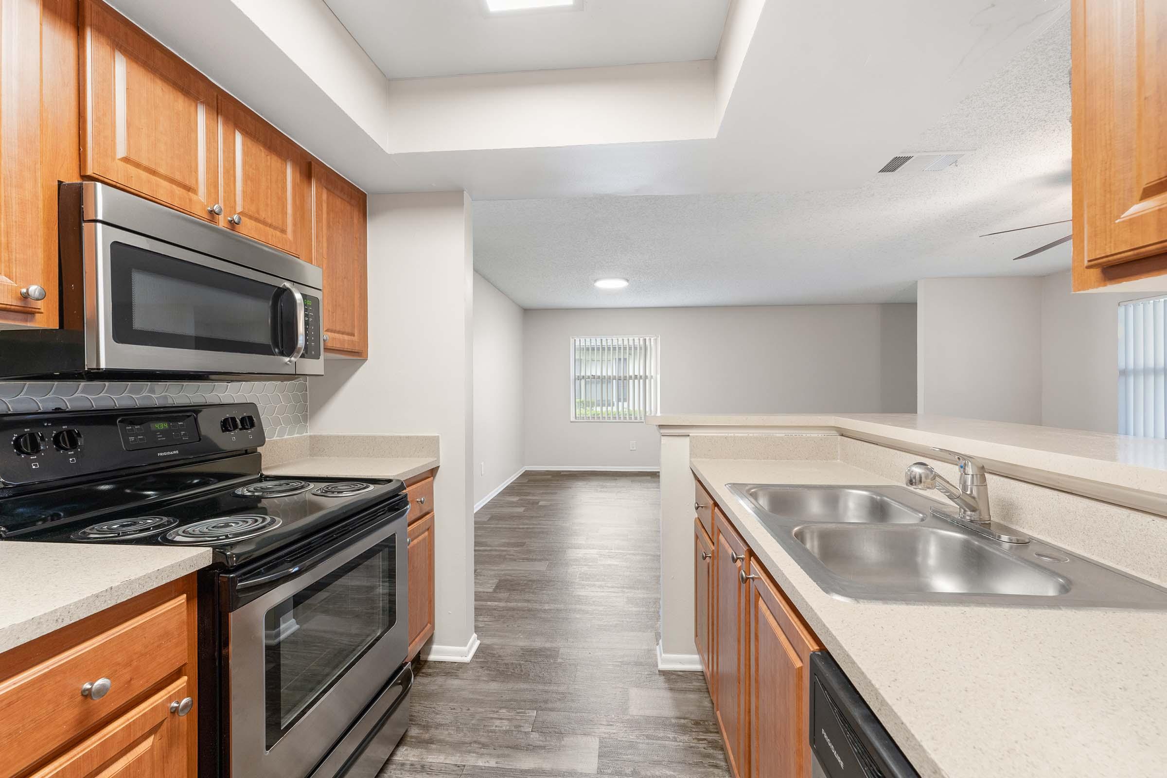 a kitchen with stainless steel appliances and wooden cabinets