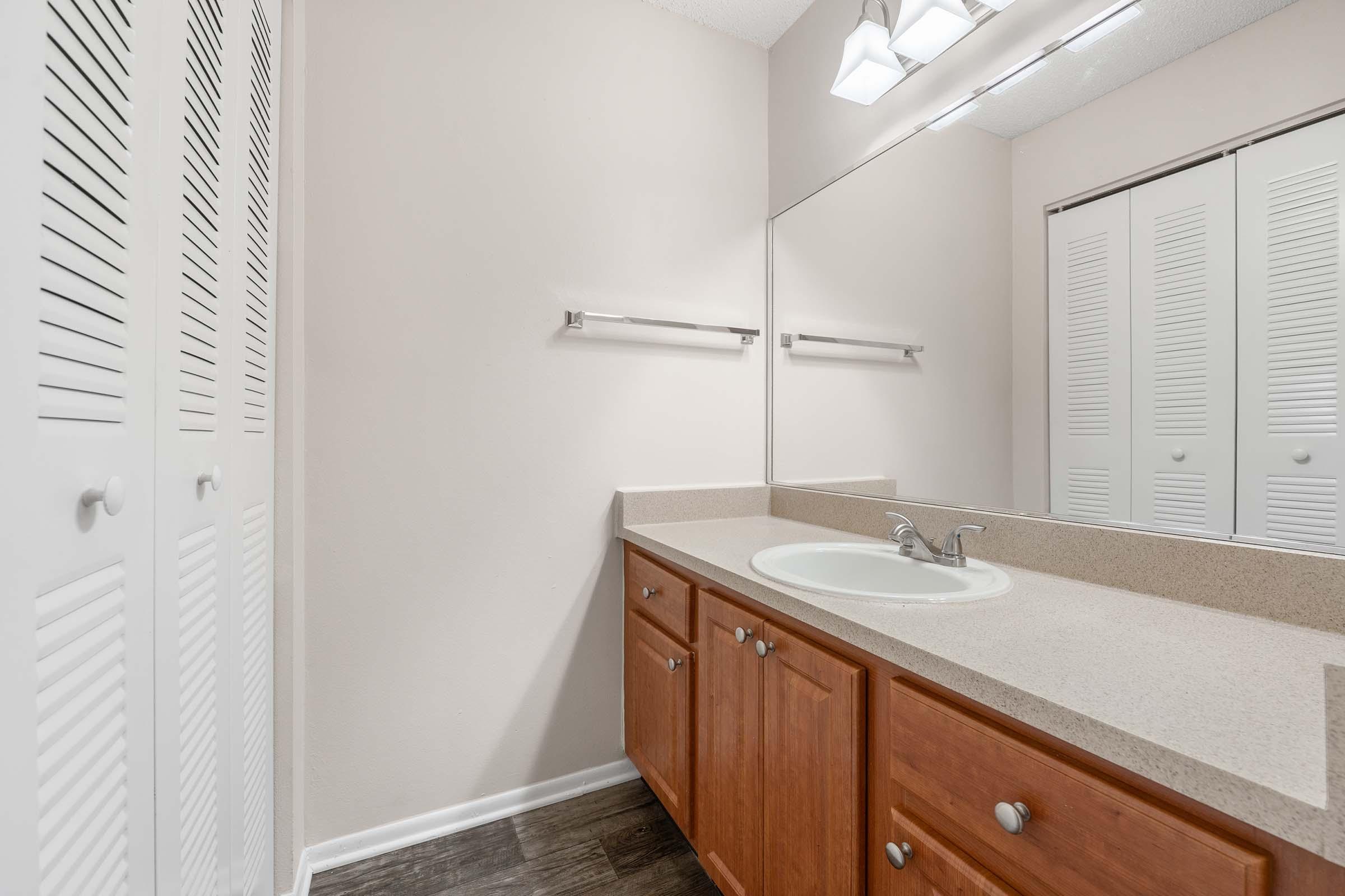 a kitchen with a sink and a mirror