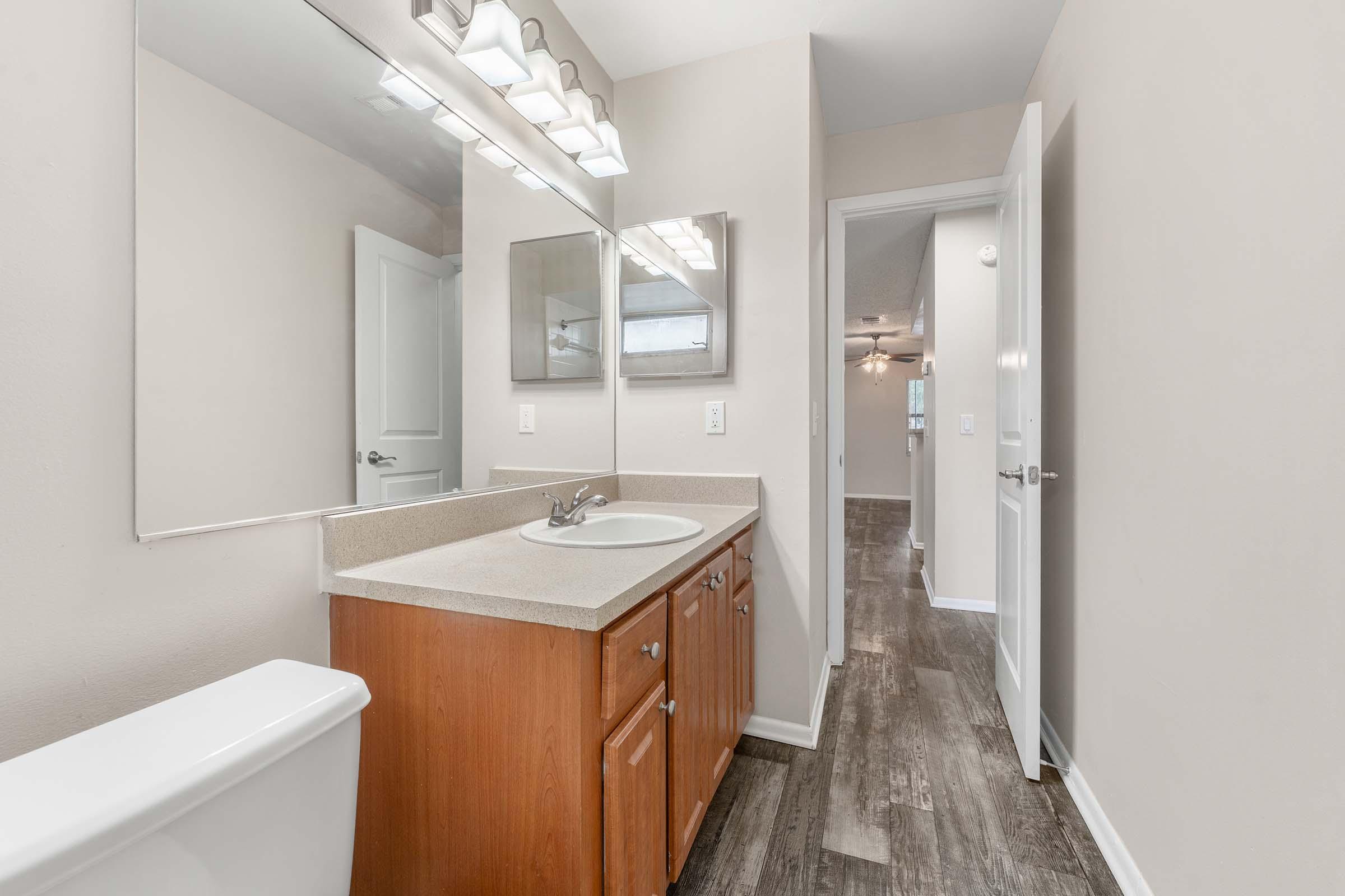 a kitchen with a sink and a mirror