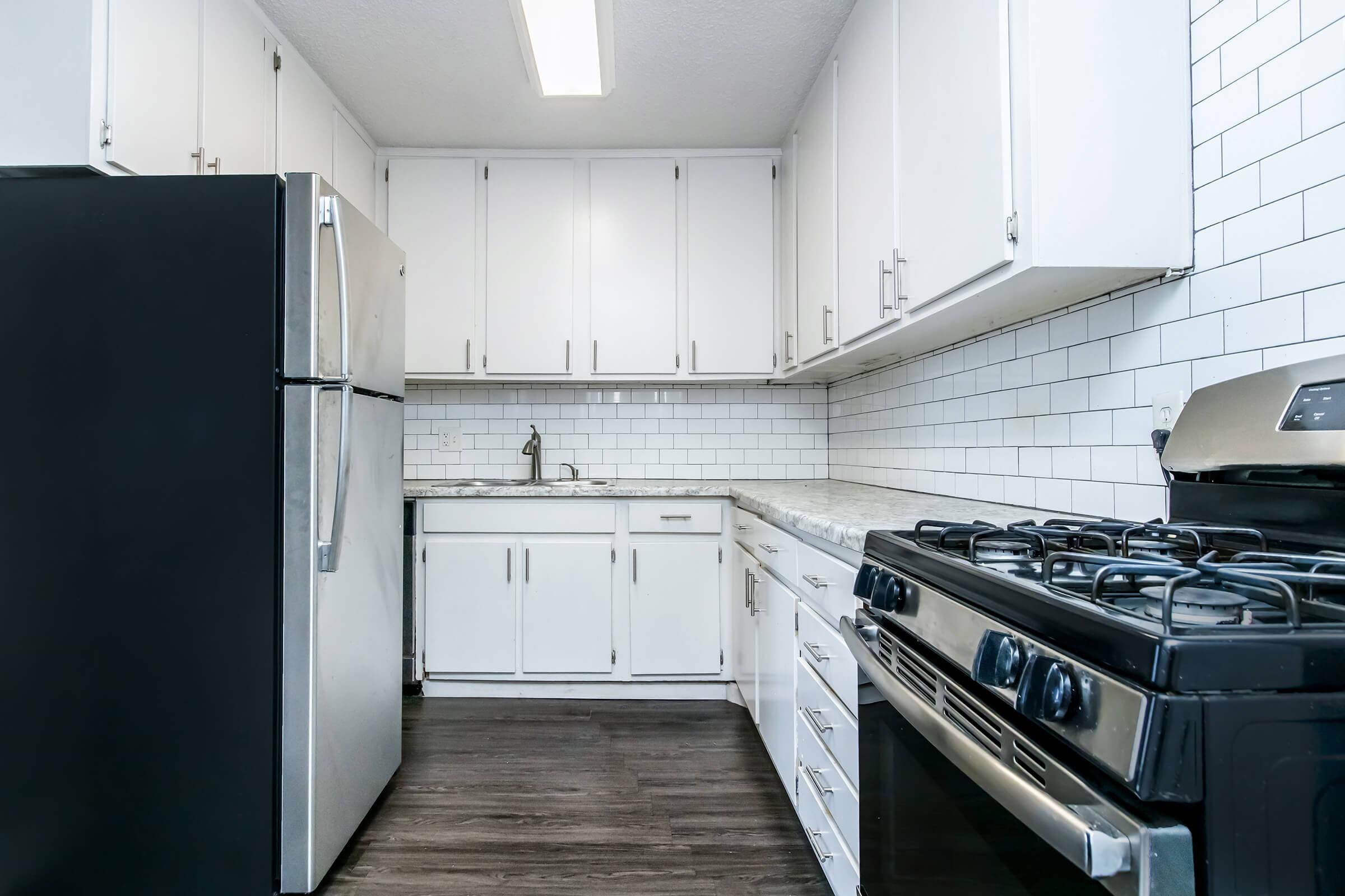 a stove top oven sitting inside of a kitchen