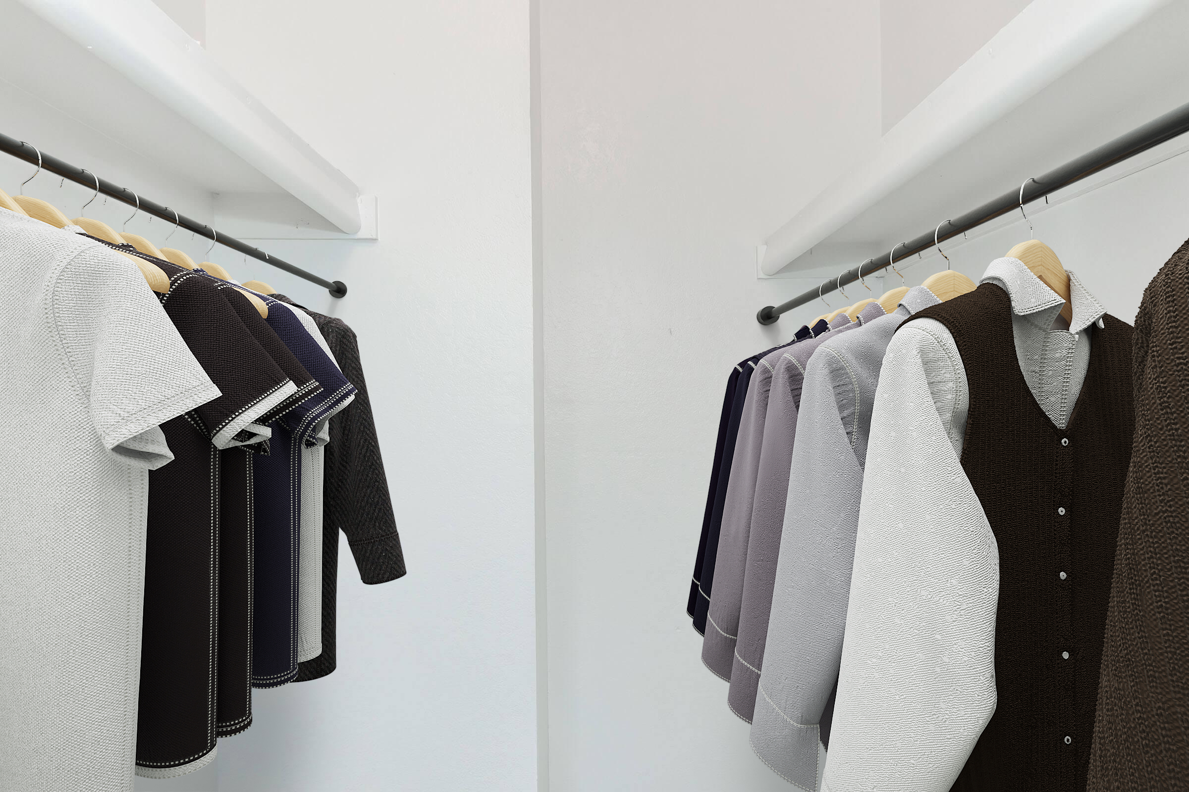 A neatly organized clothing rack displaying a variety of garments, including dresses and tops in shades of gray, black, and white. The clothes are hung on smooth, modern hangers, set against a minimalist white background that enhances the tidy and contemporary feel of the space.