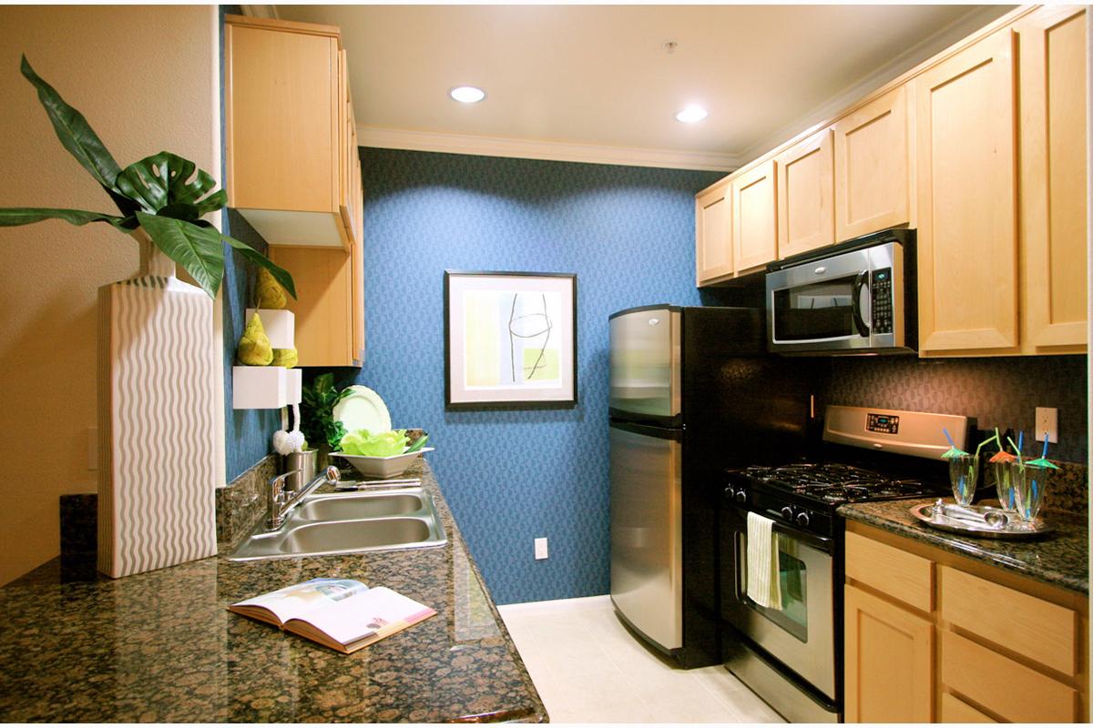 a kitchen with a stove a sink and a microwave