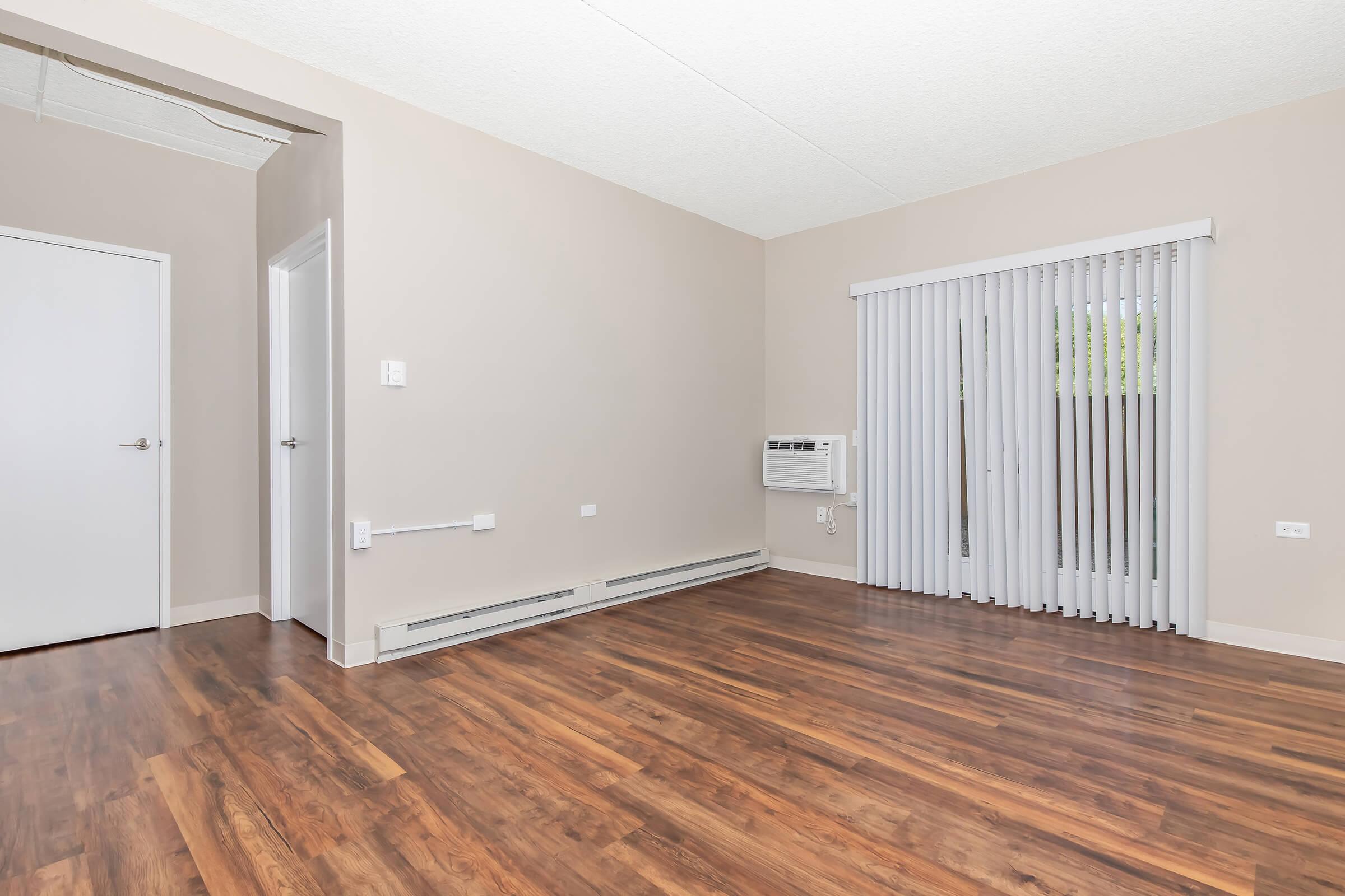 a large empty room with a wooden floor