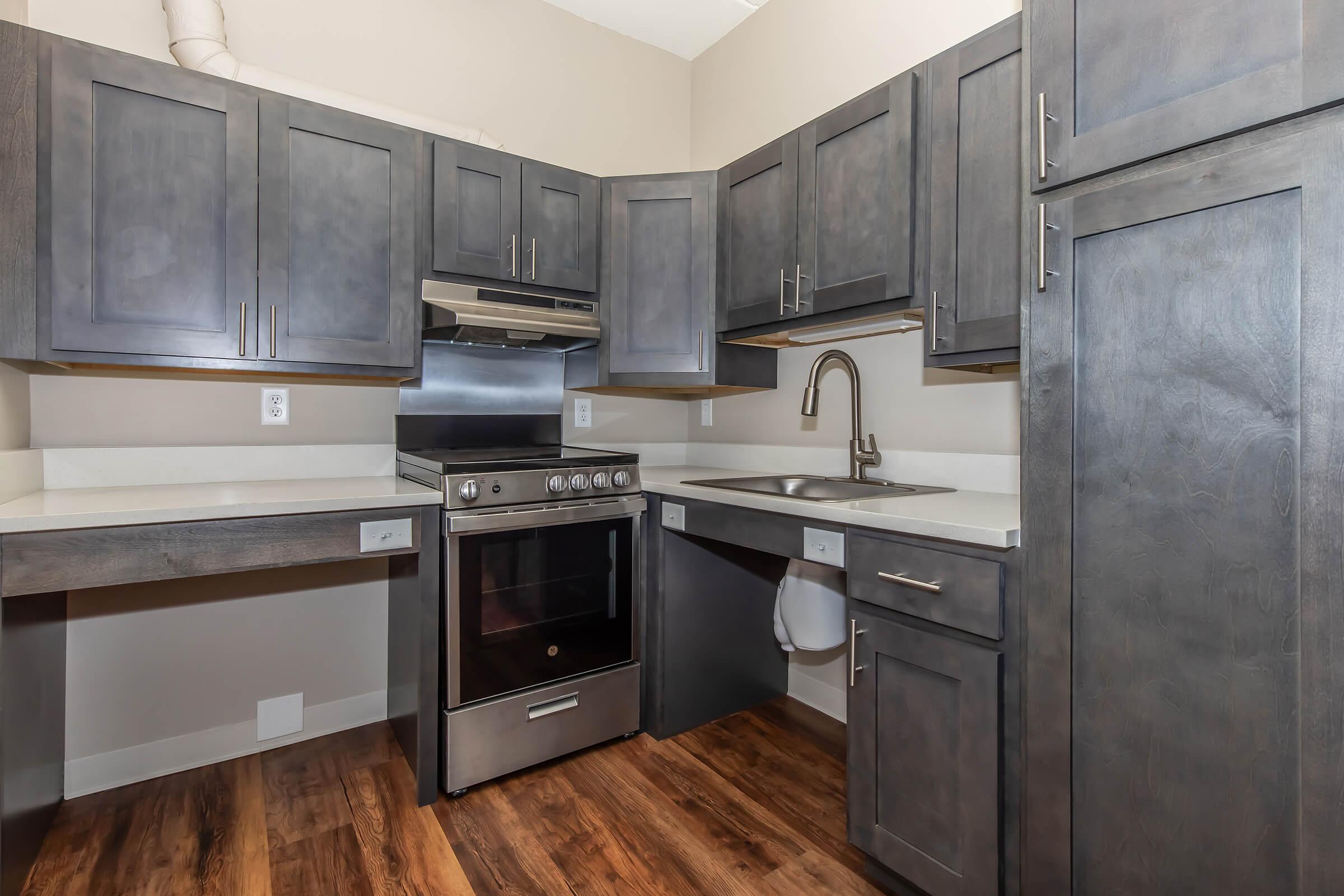 a large kitchen with stainless steel appliances and wooden cabinets