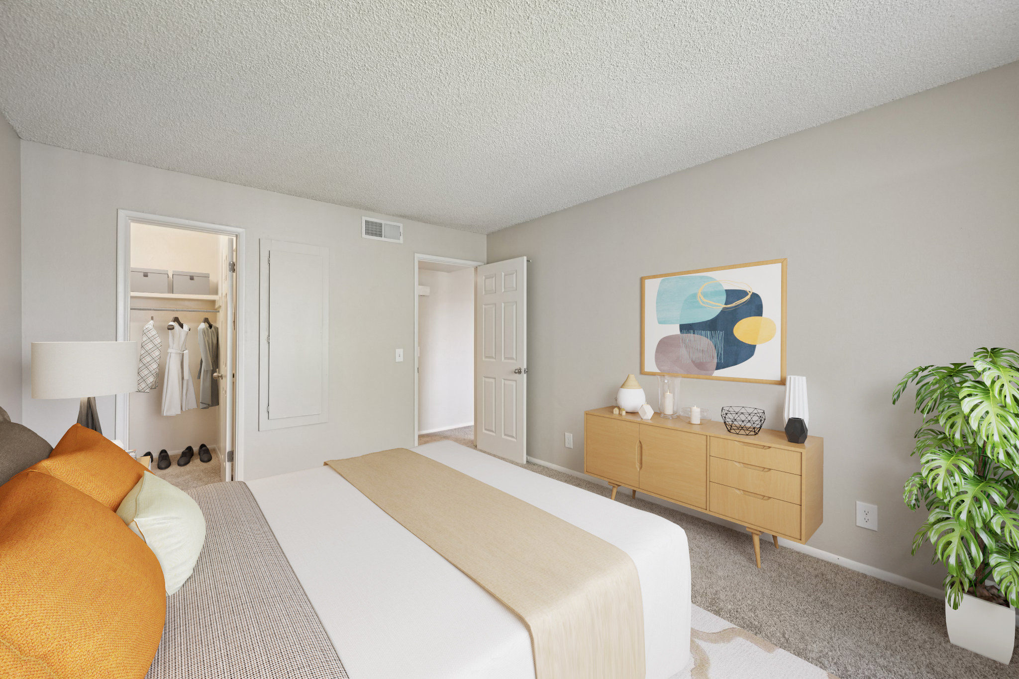 A modern bedroom featuring a bed with orange and neutral bedding, a wooden dresser displaying decorative items, and a potted plant. The room has light-colored walls and a textured ceiling. An open closet is visible in the background, showcasing neatly organized clothes. Natural light fills the space, creating a welcoming atmosphere.