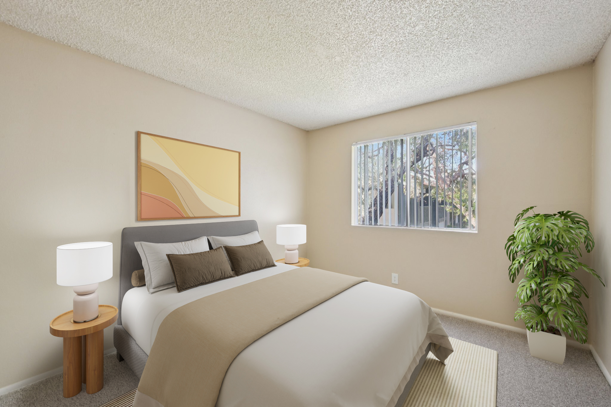 A cozy bedroom featuring a large bed with neutral bedding, two round bedside tables with lamps, a vibrant abstract artwork on the wall, a window allowing natural light and a view of outdoor greenery, and a potted plant in the corner, all set against soft beige walls and a textured ceiling.
