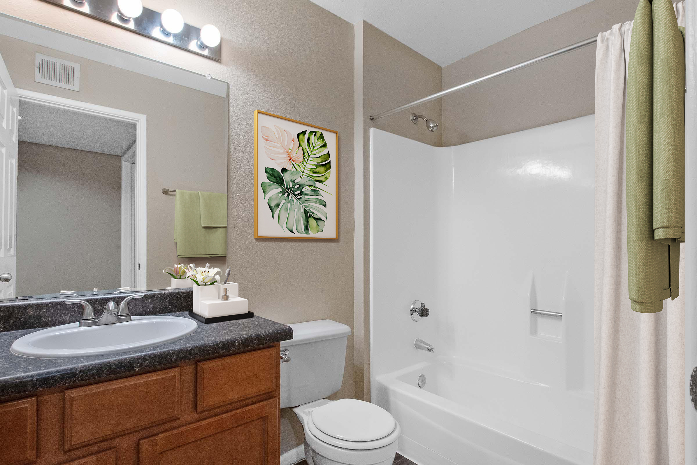 A modern bathroom featuring a bathtub with a shower, a wooden vanity with a sink, and a mirror above. There is a floral artwork on the wall, along with towels hanging nearby. The color scheme includes neutral tones, contributing to a clean and inviting atmosphere.