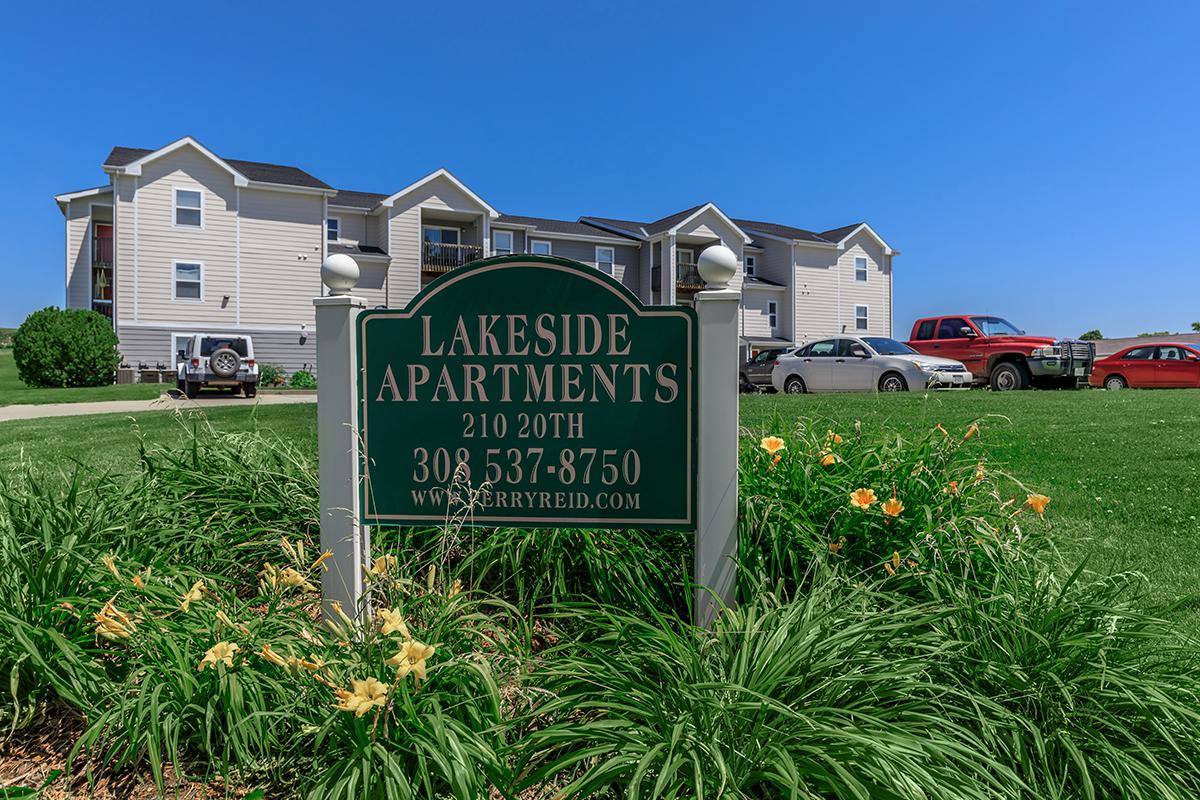 a sign in front of a green yard