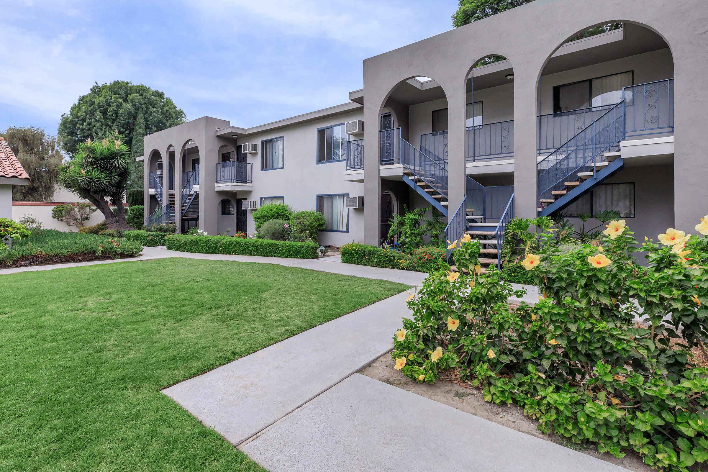 Vio Cerritos community buildings with green grass