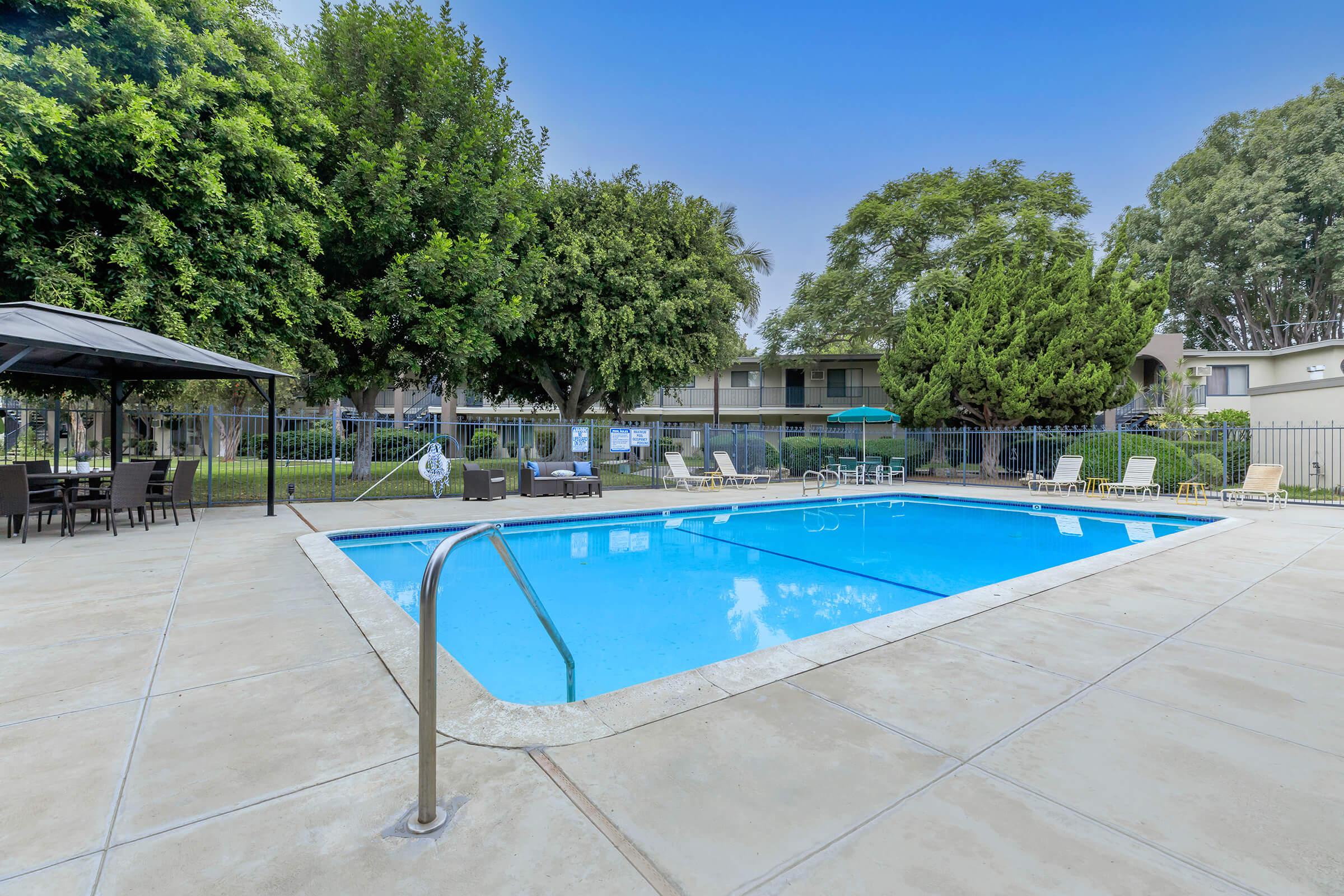 Vio Cerritos community pool with green trees