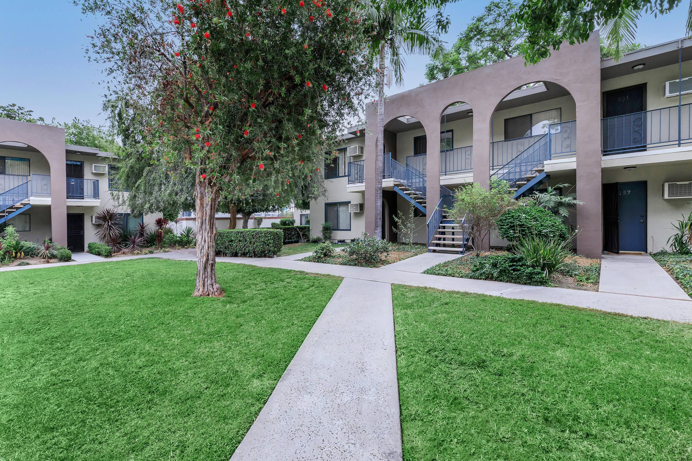 Vio Cerritos community building with green trees