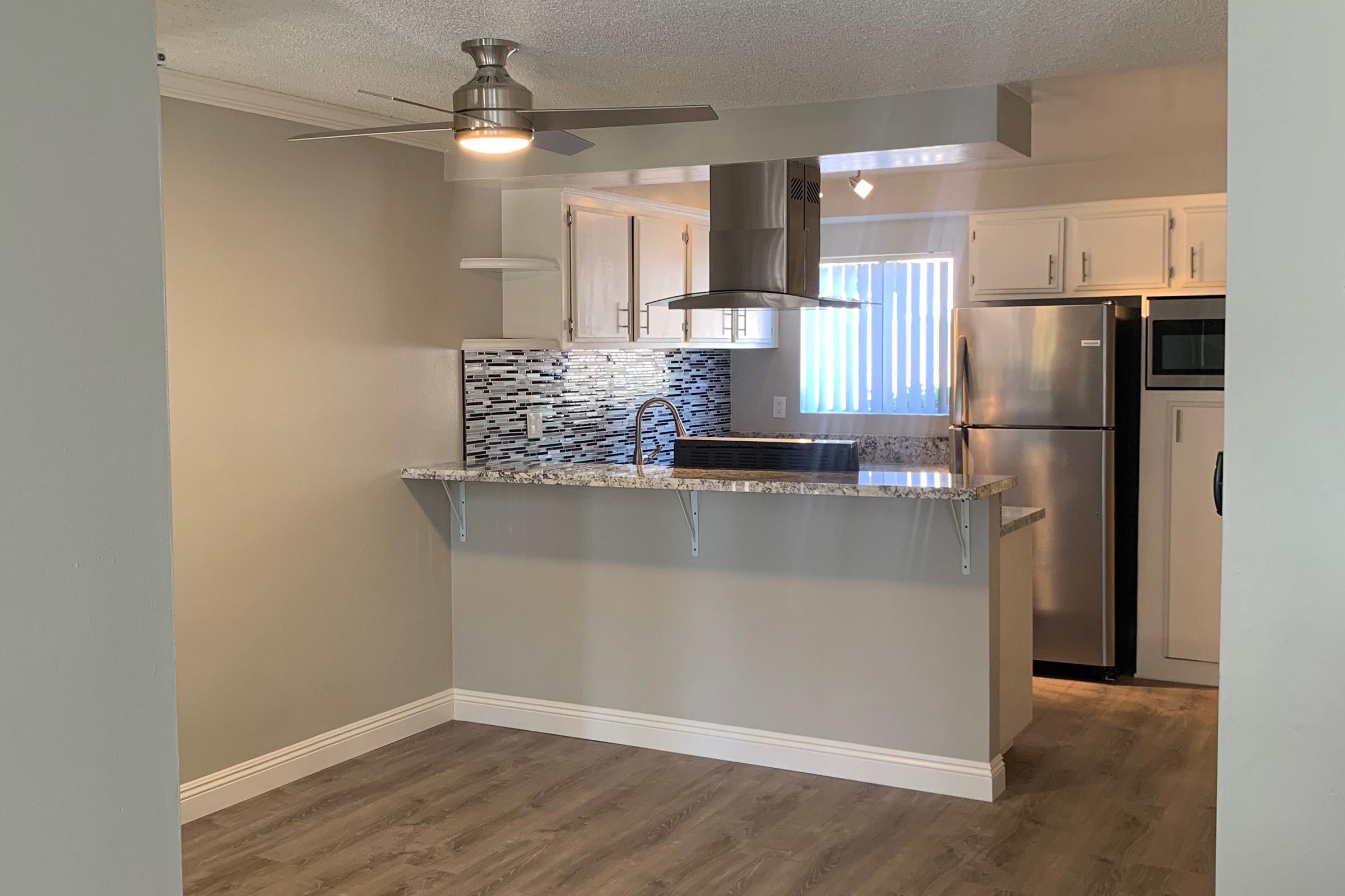 Dining room and kitchen with wooden floors