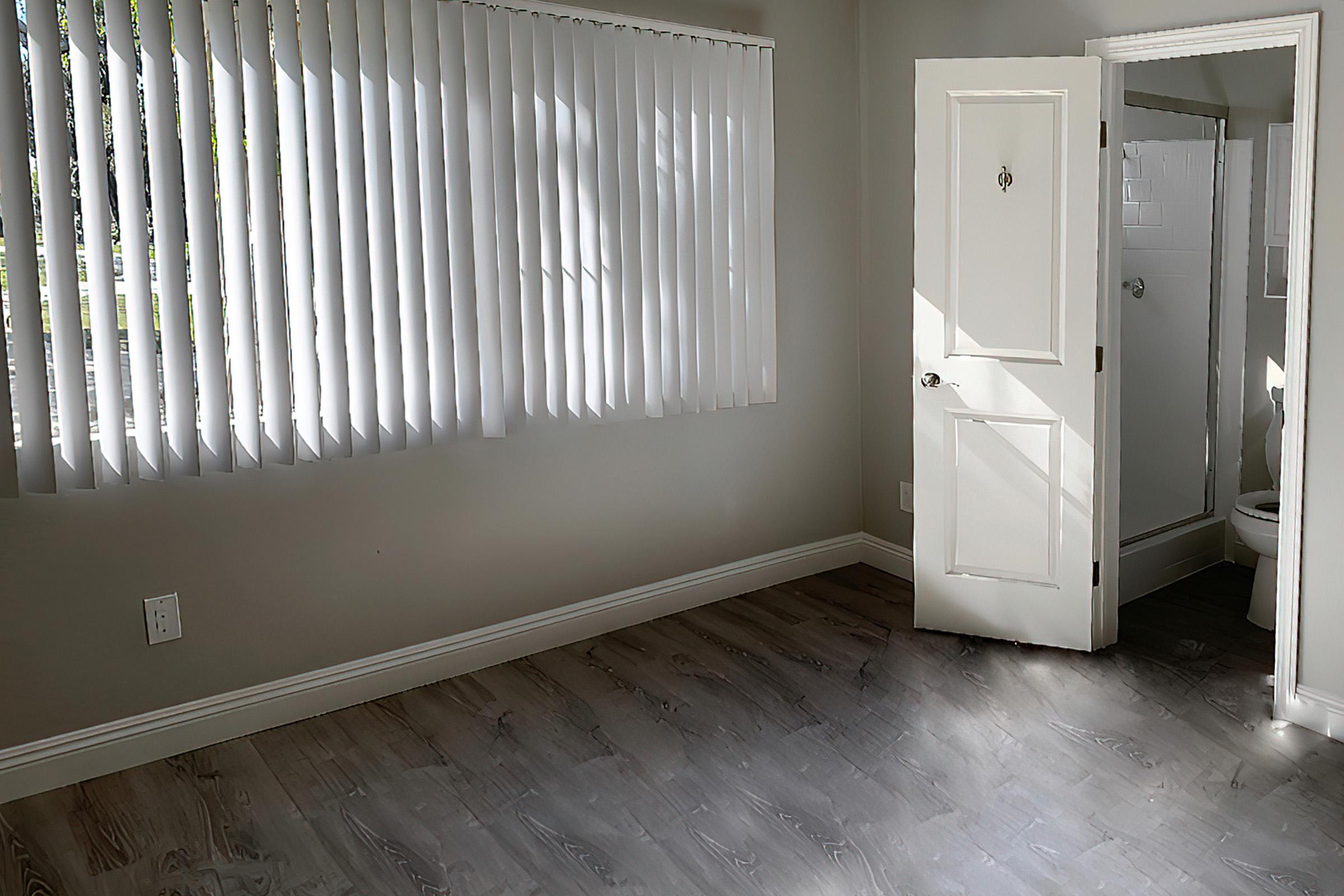 Bedroom with open door to bathroom