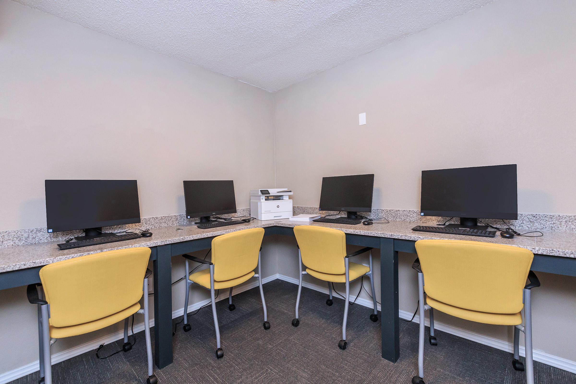 an office with a desk and chair in a room