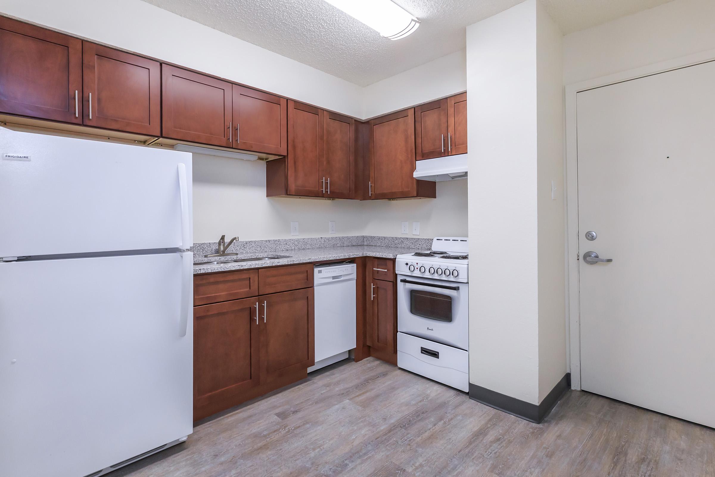 a white refrigerator freezer sitting inside of a kitchen