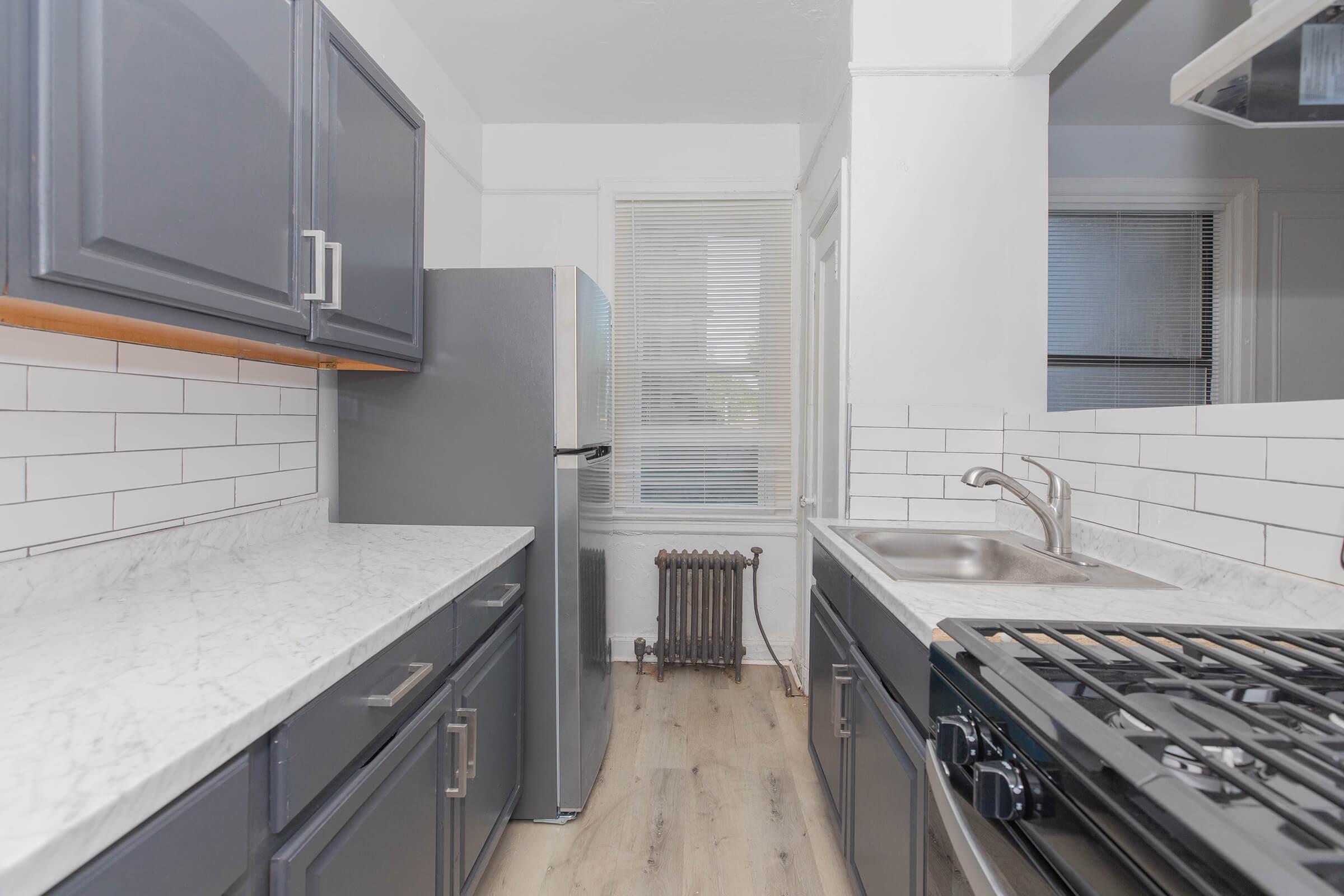 a kitchen with a stove top oven sitting next to a window