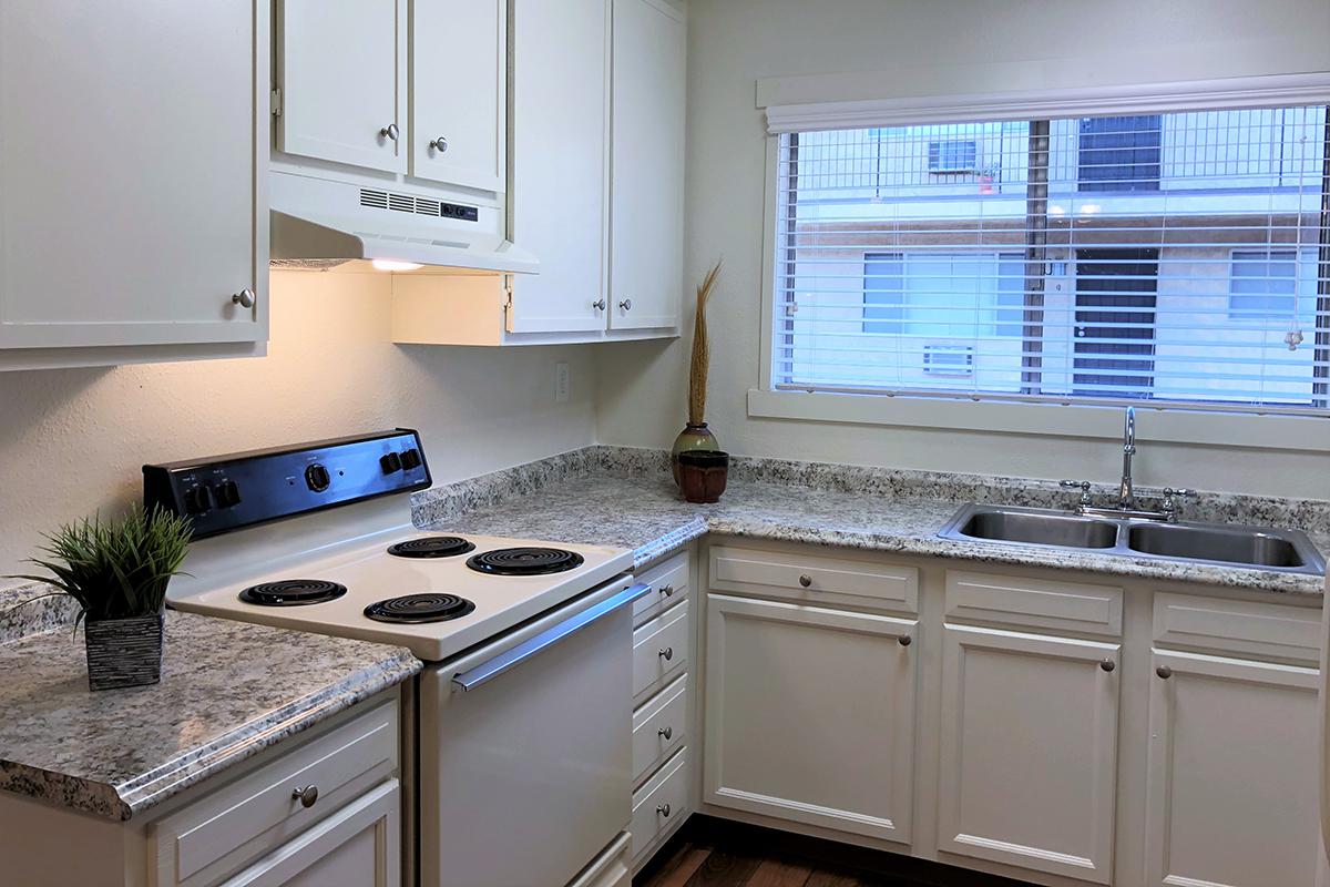 a white stove top oven sitting inside of a kitchen