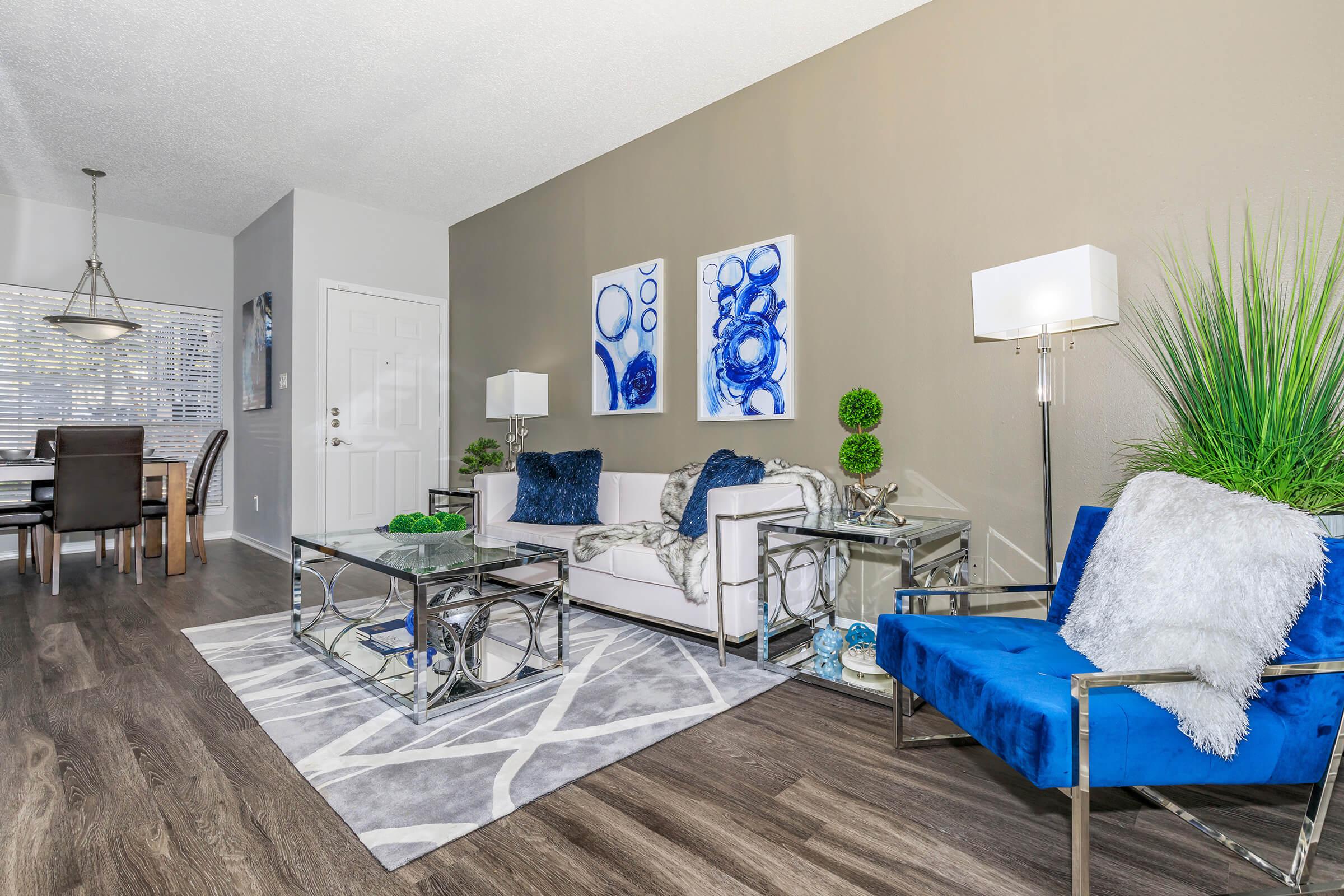 a living room filled with furniture and a blue chair