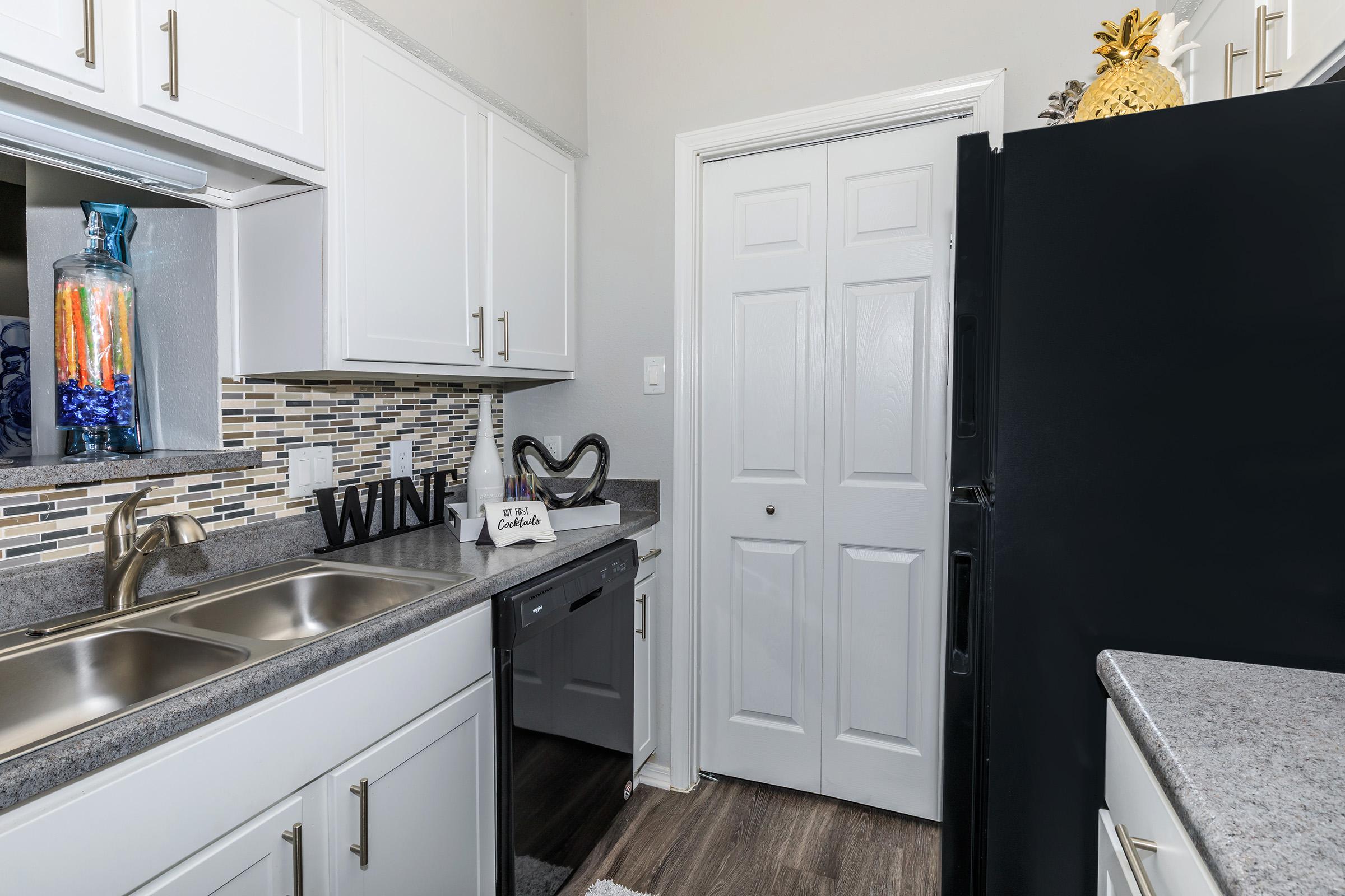 a kitchen with a sink and a refrigerator