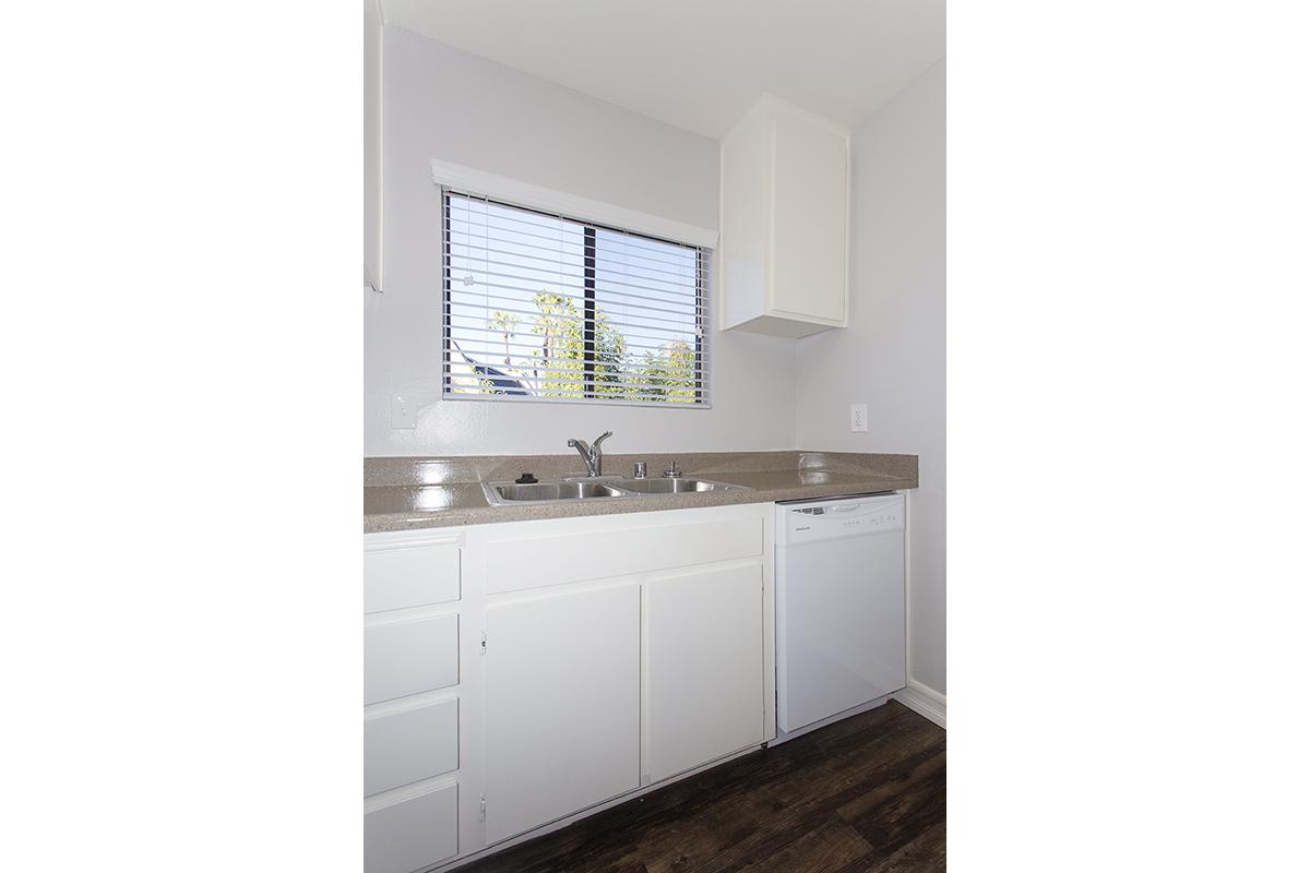 a kitchen with white cabinets