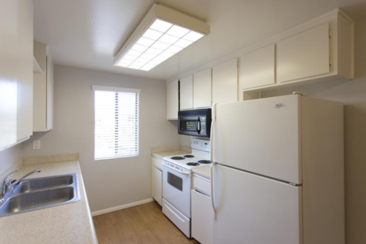 a kitchen with a stove and a refrigerator