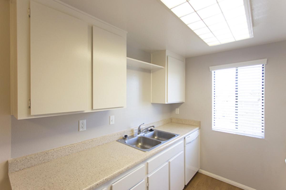 a kitchen with a sink and a mirror