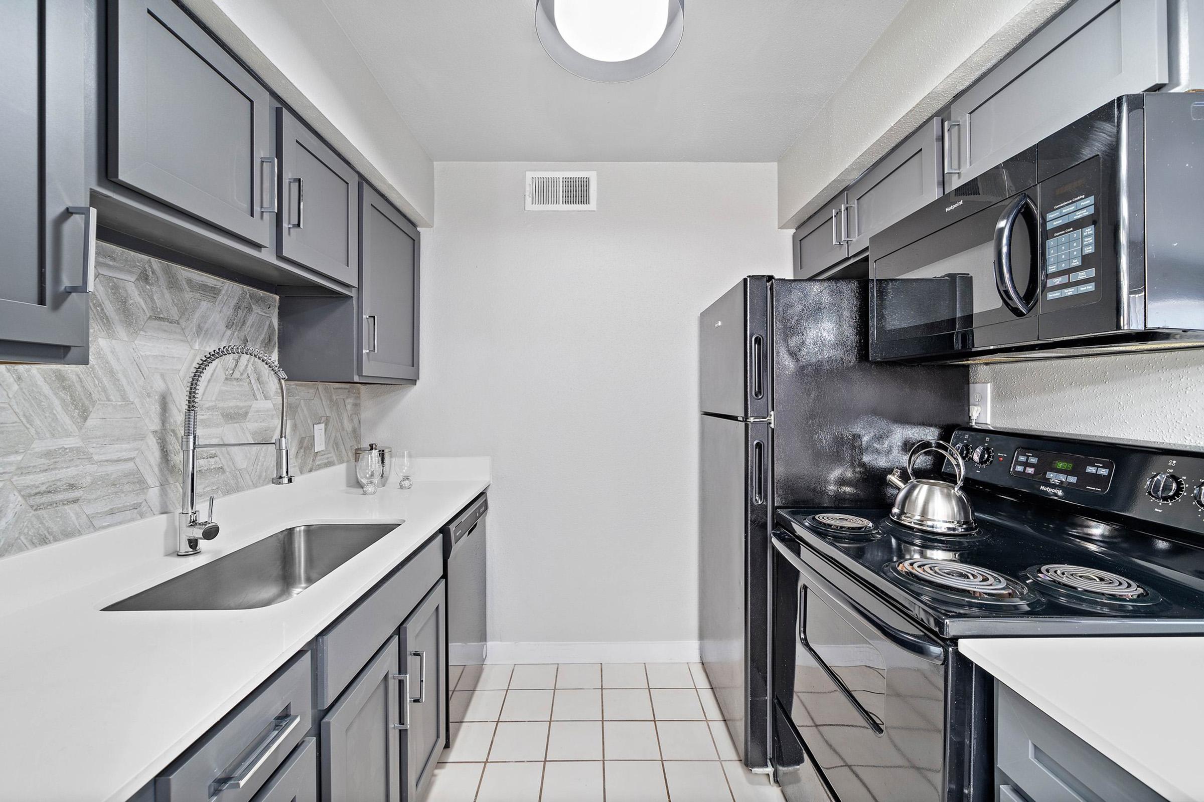 a large kitchen with stainless steel appliances