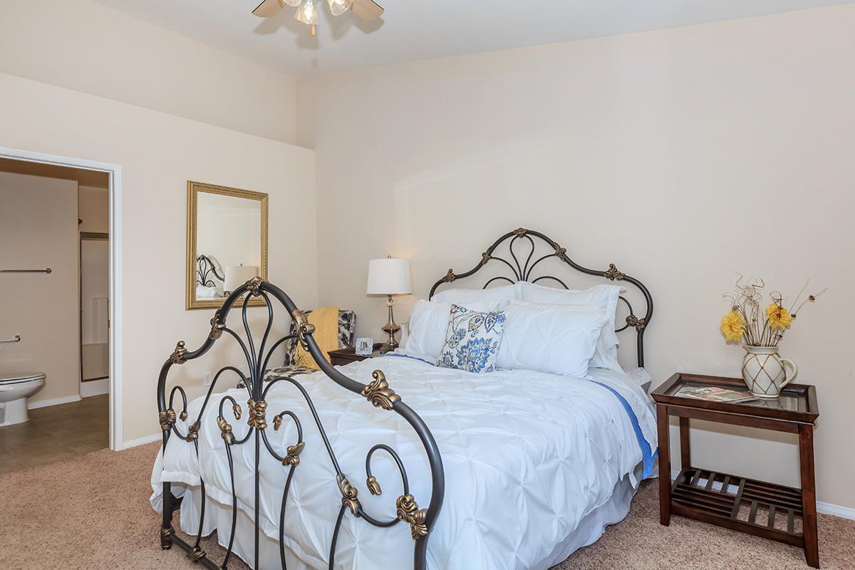a bedroom with a bed and desk in a small room