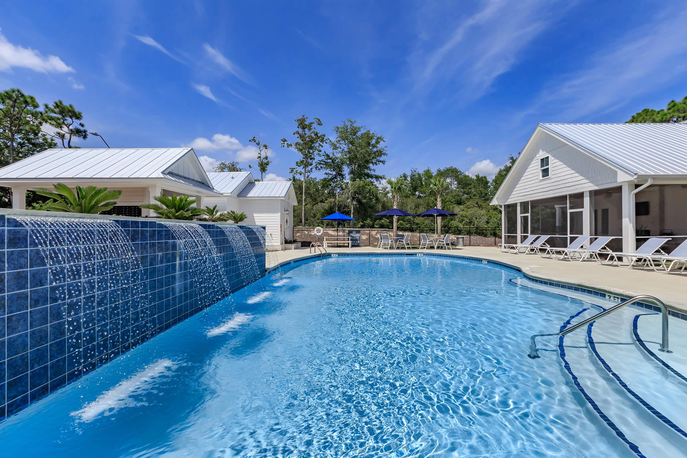 Enjoy the shimmering swimming pool at The Townhomes at Beau Rivage in Wilmington, North Carolina.