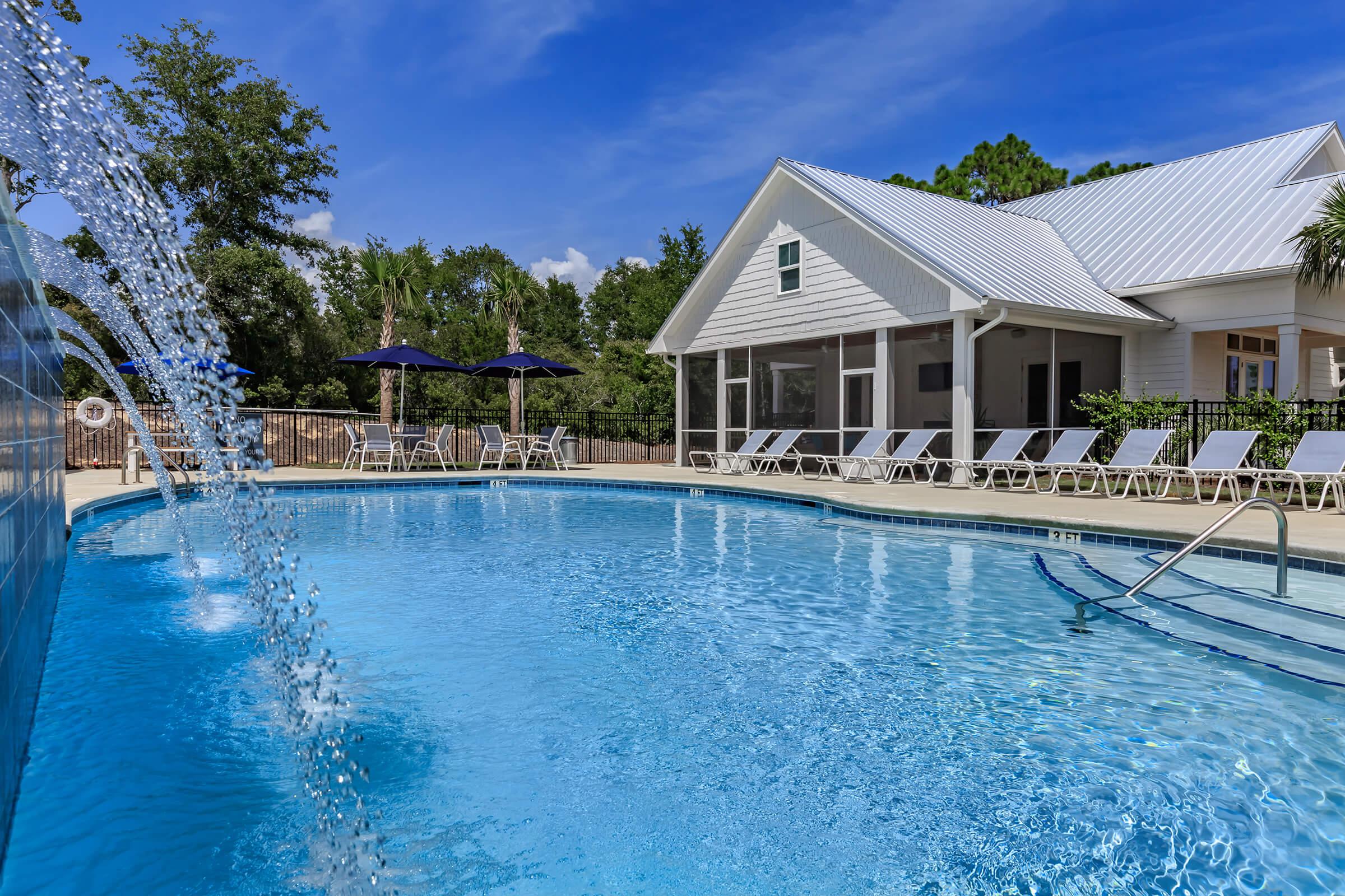 Saltwater swimming pool with waterfall at The Townhomes at Beau Rivage in Wilmington, NC.