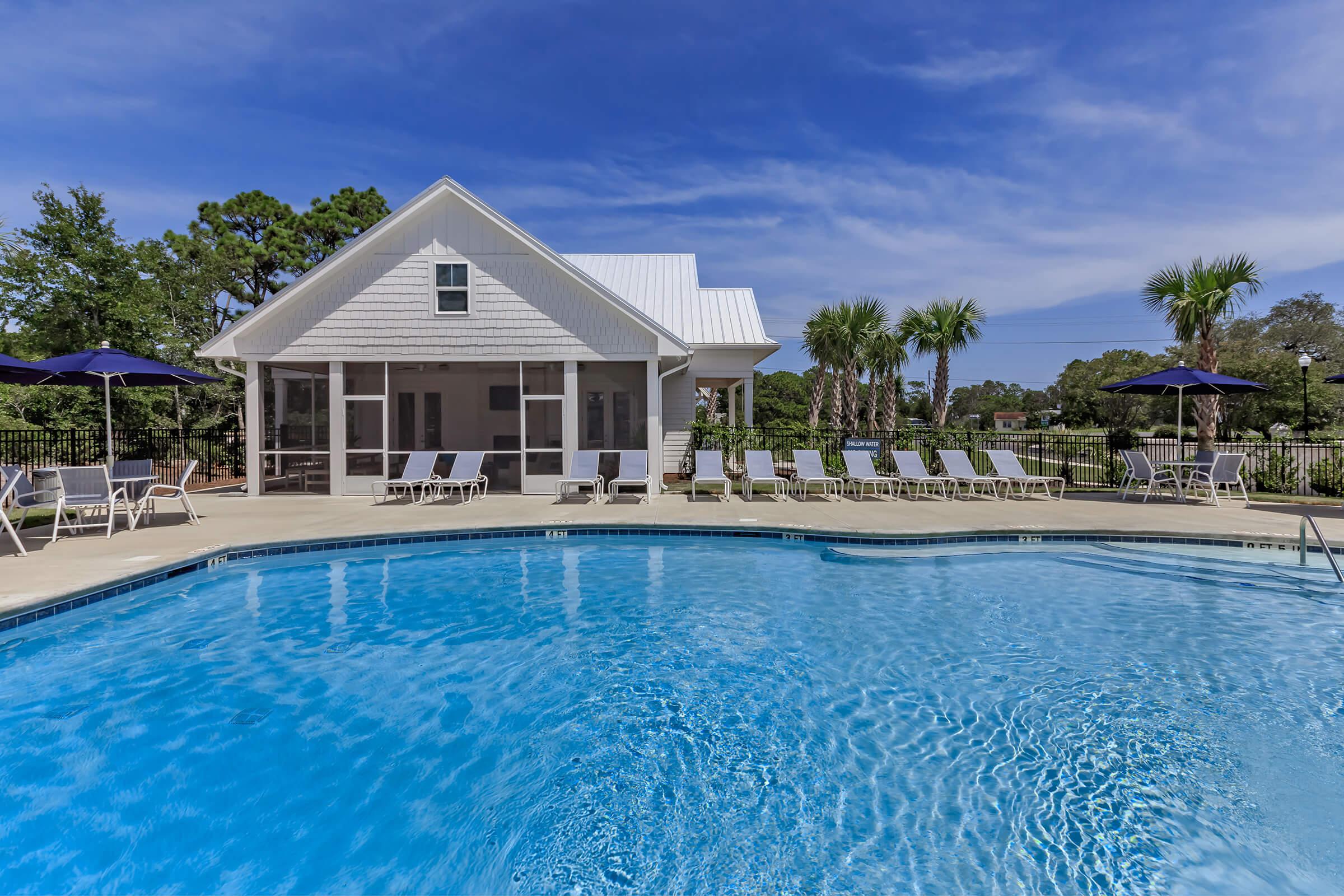 Soak up the sun at the shimmering swimming pool at The Townhomes at Beau Rivage in Wilmington, North Carolina.
