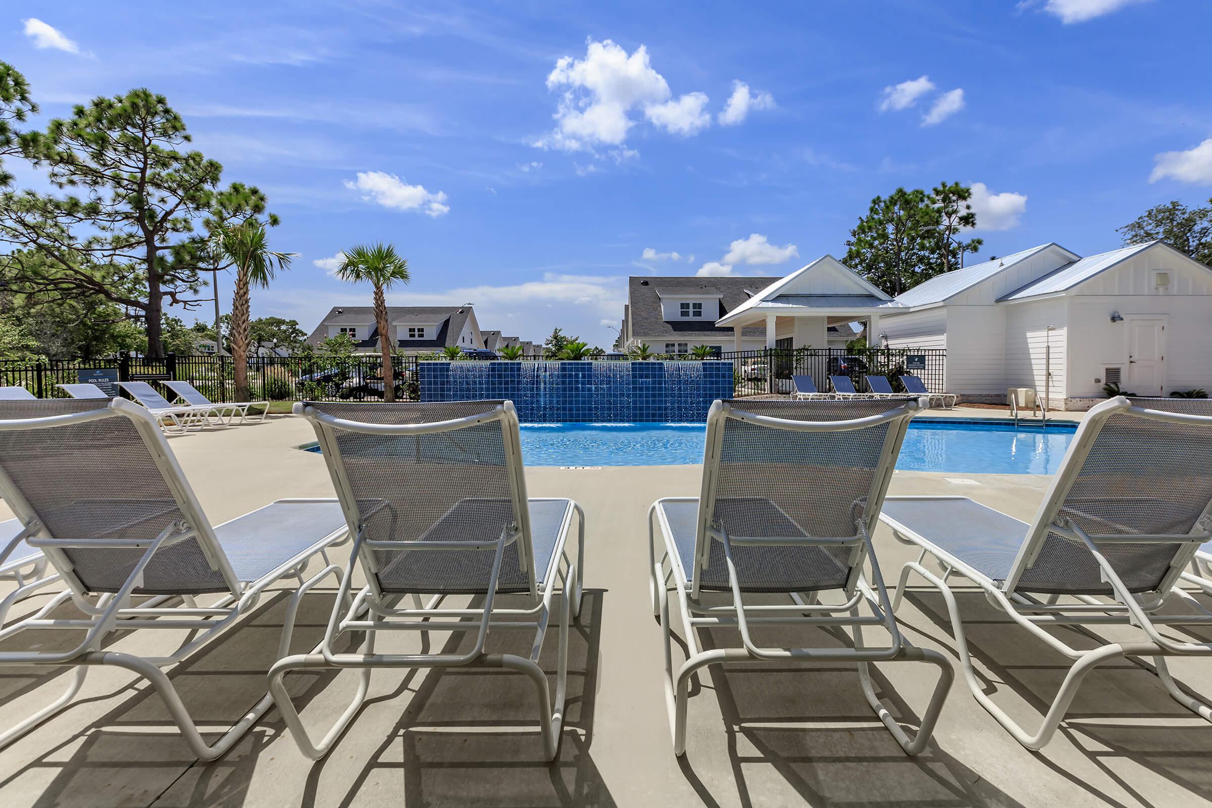 Soak up the sun by the swimming pool at The Townhomes at Beau Rivage in Wilmington, North Carolina.